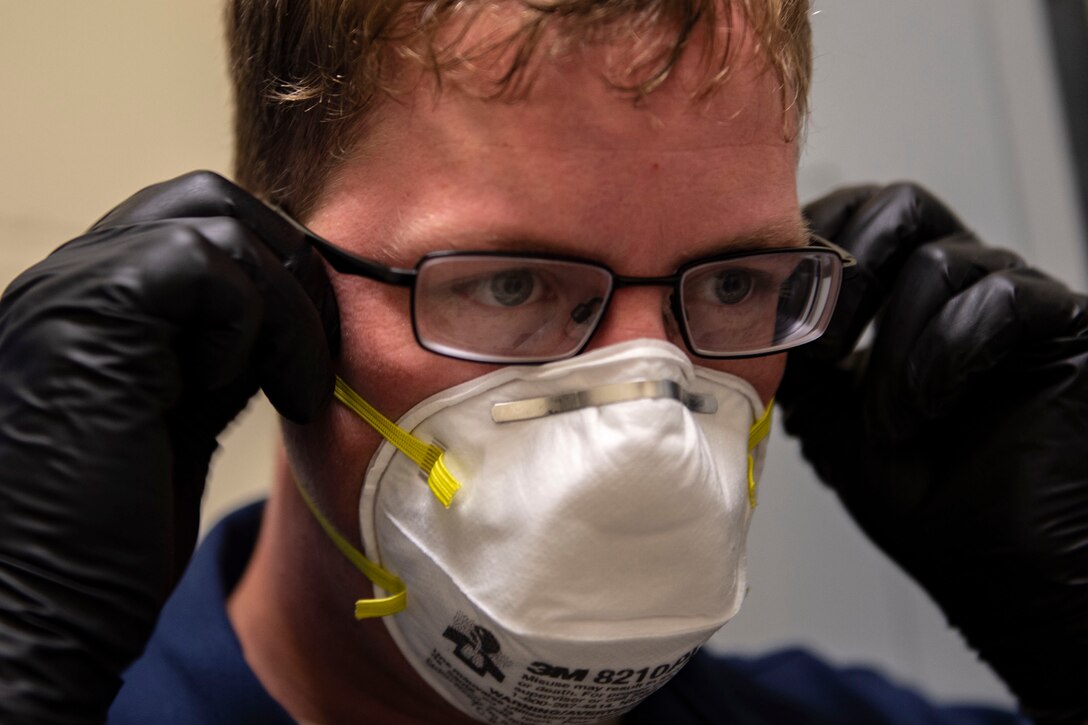 Staff Sgt. Cory Schollmeyer, 23d Civil Engineer Squadron pest management Airman, puts on a protective mask before conducting a survey treatment underneath a building Sept. 10, 2019, at Moody Air Force Base, Ga. Pest management, known as entomology, uses survey treatments to keep facilities free of pest-related health hazards, helping Moody’s Airmen stay mission ready. (U.S. Air Force photo by Airman Azaria E. Foster)
