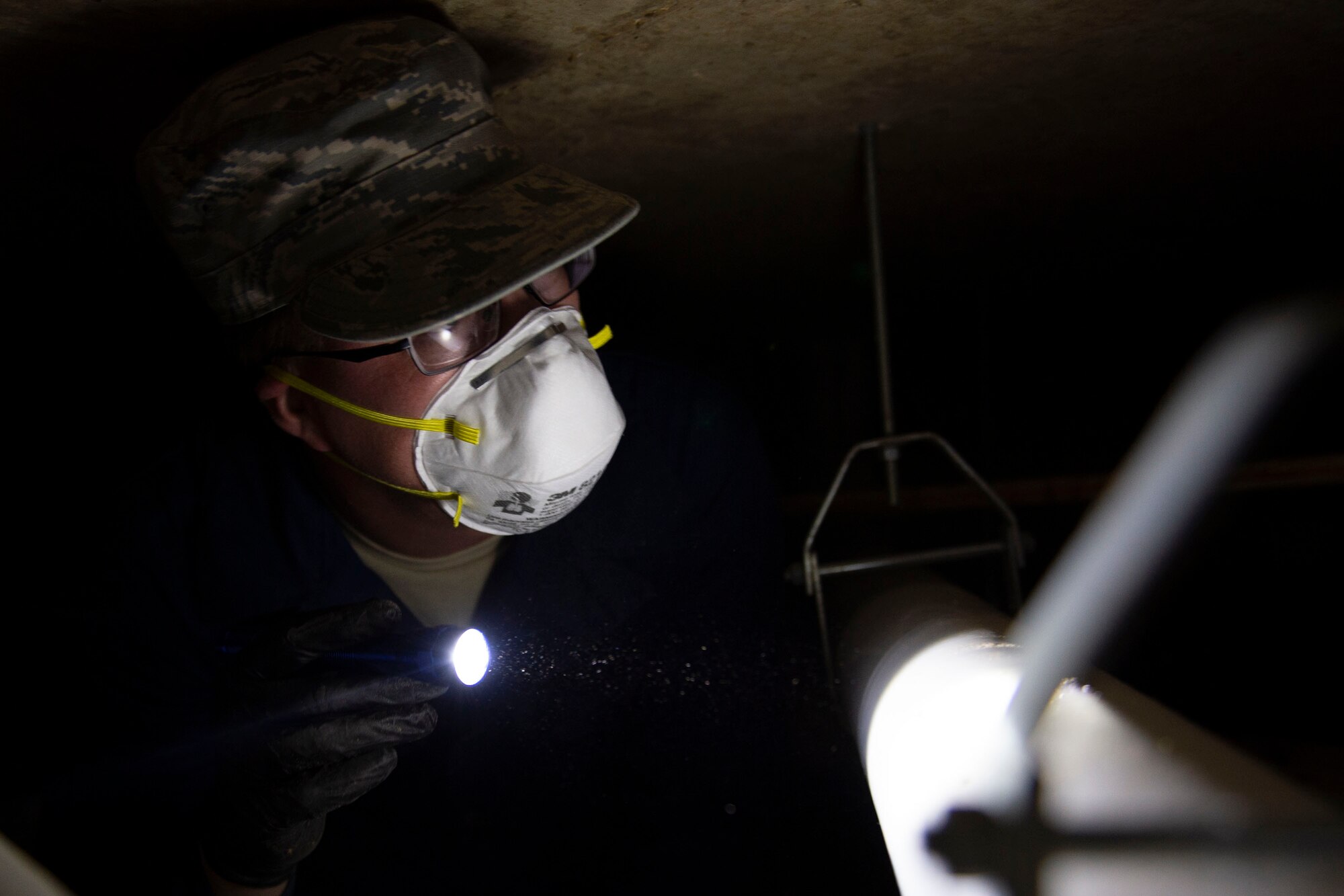 Staff Sgt. Cory Schollmeyer, 23d Civil Engineer Squadron pest management, inspects a pipe while conducting a survey treatment underneath a building Sept. 10, 2019, at Moody Air Force Base, Ga. Pest management, known as entomology, uses survey treatments to keep facilities free of pest-related health hazards, helping Moody’s Airmen stay mission ready. (U.S. Air Force photo by Airman Azaria E. Foster)