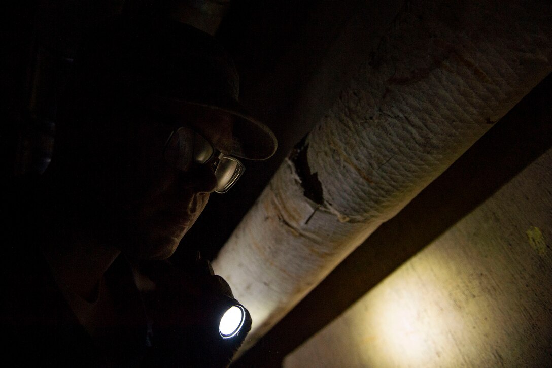 Senior Airman Aaron Rasch, 23d Civil Engineer Squadron pest management, shines a flashlight while conducting a survey treatment underneath a building Sept. 10, 2019, at Moody Air Force Base, Ga. Pest management, known as entomology, uses survey treatments to keep facilities free of pest-related health hazards, helping Moody’s Airmen stay mission ready. (U.S. Air Force photo by Airman Azaria E. Foster)