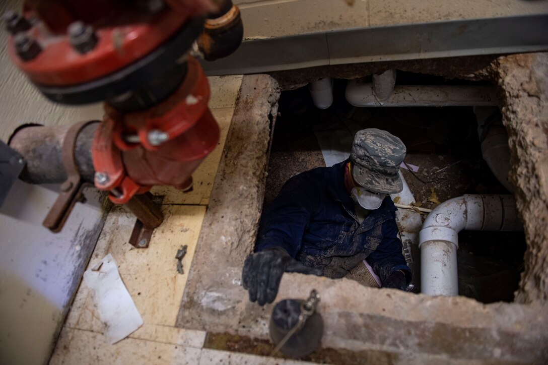 Staff Sgt. Cory Schollmeyer, 23d Civil Engineer Squadron pest management, goes underneath a building to conduct a survey treatment Sept. 10, 2019, at Moody Air Force Base, Ga. Pest management, known as entomology, uses survey treatments to keep facilities free of pest-related health hazards, helping Moody’s Airmen stay mission ready. (U.S. Air Force photo by Airman Azaria E. Foster)