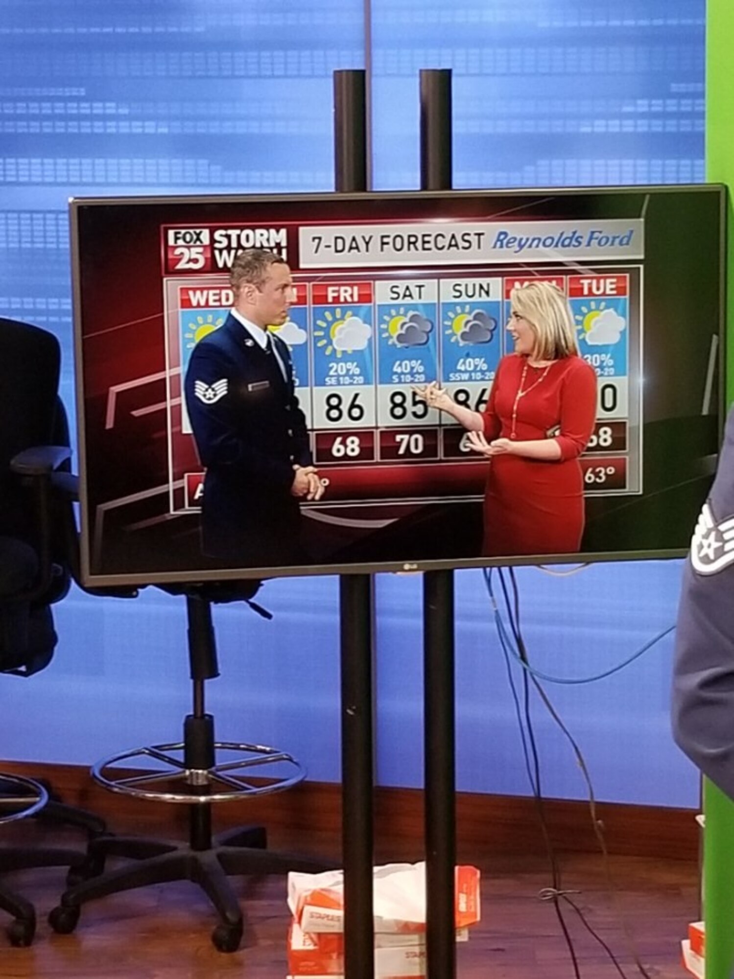 An image of SSgt. Brandon Feister giving the forecast with local media station.
