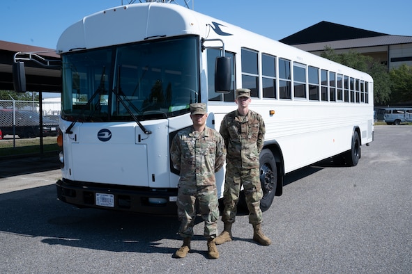 U.S. Air Force Staff Sgt. Christopher Carpe, 81st Logistics Readiness Squadron ground transportation and equipment support NCO in charge, and Airman 1st Class Jared Hill, ground transportation personnel, pose for a photo on Keesler Air Force Base, Sept. 26, 2019. Carpe and Hill assisted in transporting elderly residents of the Seashore Oaks Assisted Living Facility away from the area after a fire evacuation. (U.S. Air Force photo by Airman 1st Class Kimberly L. Mueller)