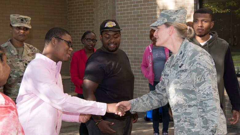 Col. Jocelyn J. Schermerhorn, 11th Wing vice commander, shakes hands with a Project Search intern at Joint Base Andrews, Aug. 29, 2019. Project Search, which began in 1996 at the Cincinnati Children's Hospital, establishes internships at local businesses and government organizations for students with disabilities. (U.S. Air Force photo by Airman 1st Class Spencer J. Slocum)