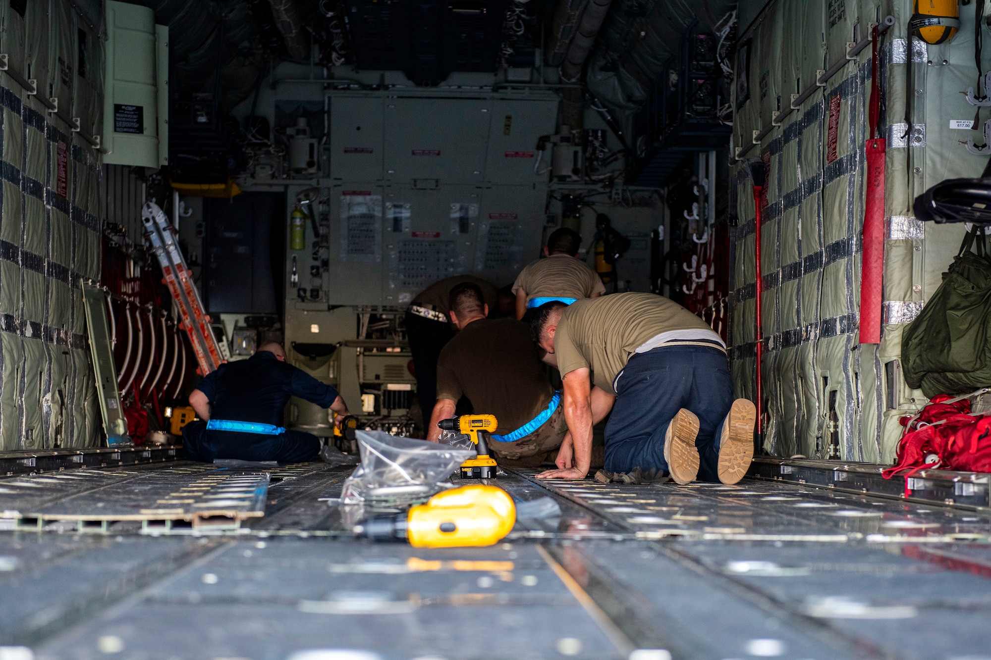 Airmen with the 71st Aircraft Maintenance Unit remove cargo floor panels during preparation of an HC-130J Combat King II for a situational awareness communication upgrade (SACU) modification Sept. 25, 2019, at Moody Air Force Base, Ga. The panels are removed to allow access to the area inside the aircraft where the SACU will be installed. This SACU will enhance the aircraft’s ability to communicate with personnel on the ground during search and rescue operations. (U.S. Air Force photo by Senior Airman Erick Requadt)