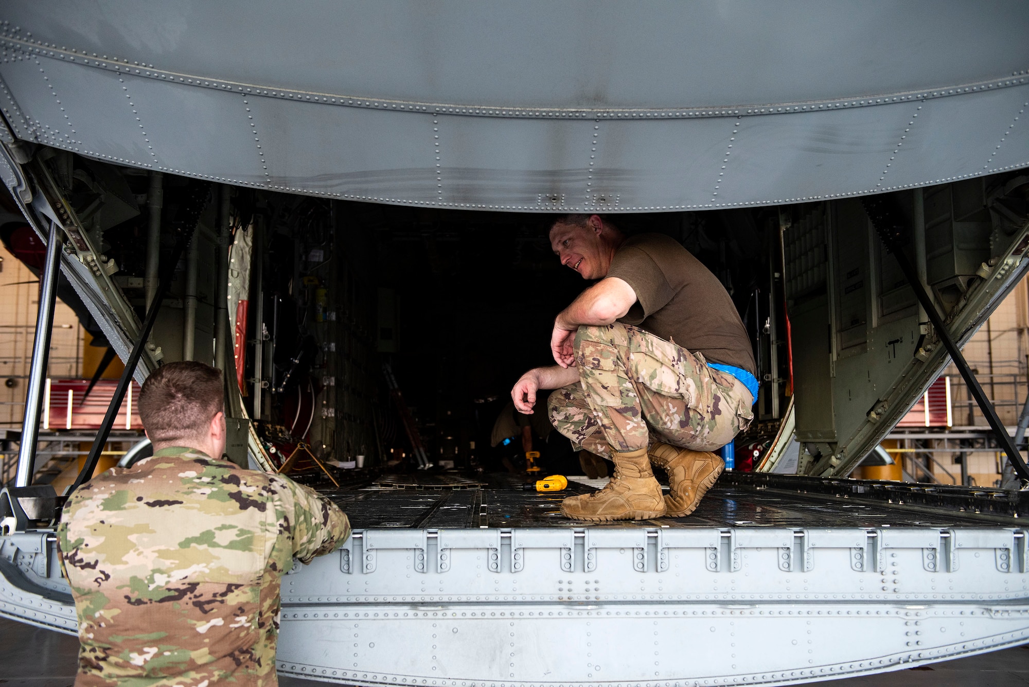 Tech. Sgt. Phillip Horton, right, 71st Aircraft Maintenance Unit (AMU) crew chief, speaks with 1st Lt. Derek Mundell, 71st AMU assistant officer in charge, during preparation of an HC-130J Combat King II for a situational awareness communication upgrade (SACU) modification Sept. 25, 2019, at Moody Air Force Base, Ga. This SACU will enhance the aircraft’s ability to communicate with personnel on the ground during search and rescue operations. (U.S. Air Force photo by Senior Airman Erick Requadt)