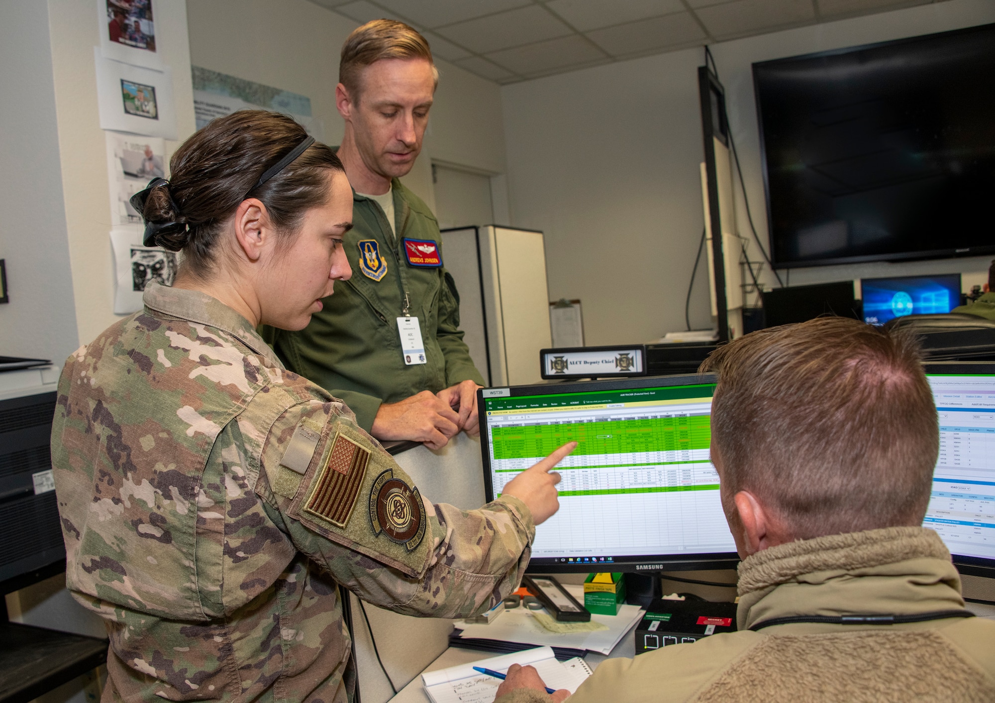U.S. Air Capt. Lauren Allen, left, 321st Air Mobility Operations Squadron executive officer, Maj. Andreas Johnsen, center, 349th AMOS airlift control team chief and Tech. Sgt. Sam Caryl, 321st AMOS squadron requirements planner, study data files at the Weapons Systems Suite in the Air Operations Center during exercise Mobility Guardian Sept. 25, 2019, at Travis Air Force Base, California. MG19 is Air Mobility Command’s flagship exercise for large-scale, rapid global mobility operations. Forty-six U.S. aircraft joined aircraft from 29 international partners, along with more than 4,000 U.S. and international Air Force, Army, Navy and Marine Corps aviators. (U.S. Air Force photo by Heide Couch)