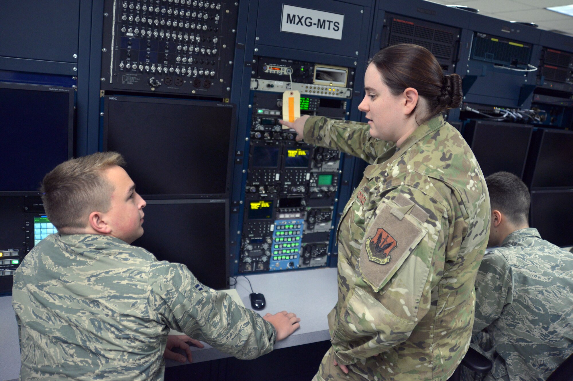 Airmen train on a replica of an aircraft computer system.