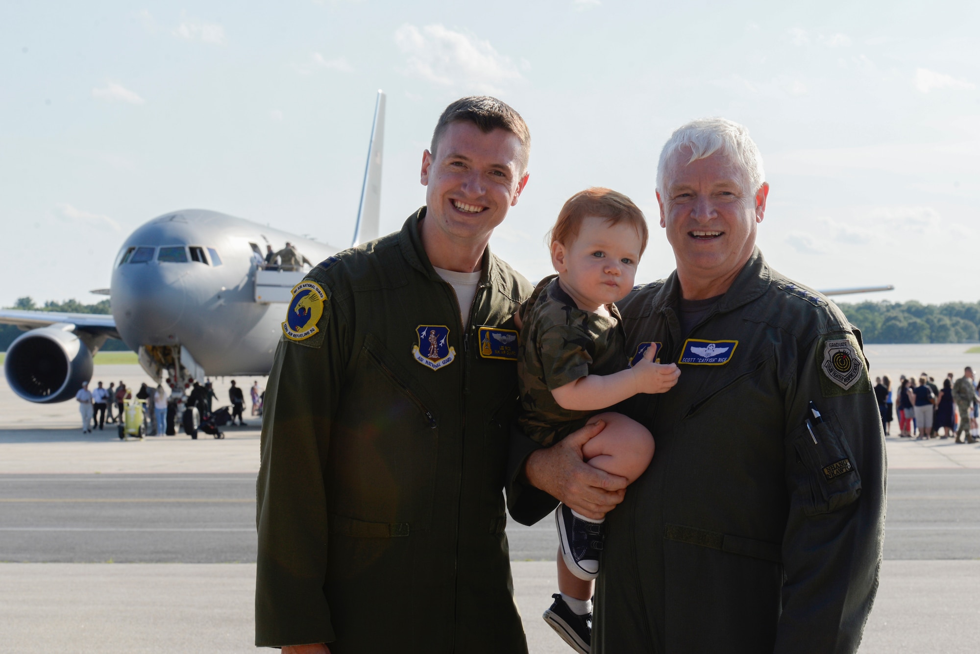 Lt. Gen. L. Scott Rice, Director of the Air National Guard, poses with his son, Capt. Leon Rice, a pilot assigned to the 157th Air Refueling Wing, and his grandson in front of the new KC-46A Pegasus Aug. 8, 2019 at Pease Air National Guard Base, N.H. Rice celebrated his last flight in his Air Force career, flying in with his son back to their home state and delivering the first KC-46 to Pease. (U.S. Air National Guard photo by Senior Airman Victoria Nelson)
