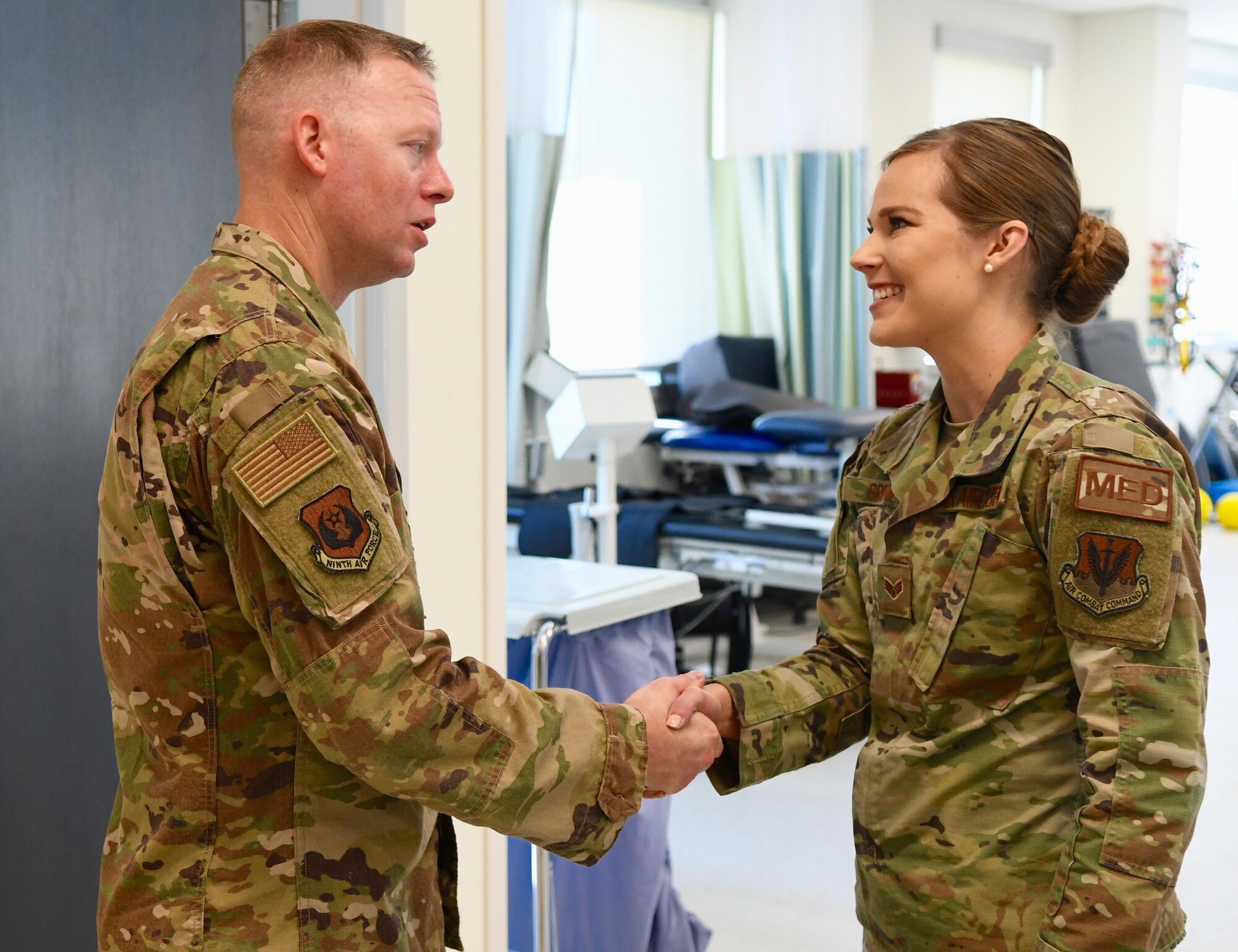 U.S. Air Force Chief Master Sgt. Benjamin W. Hedden, left, Ninth Air Force command chief, greets Senior Airman Mariah Griffin, 4th Medical Operations Squadron physical therapy specialist at the base clinic on Seymour Johnson Air Force Base, N.C., Sept. 24, 2019. During his trip, Hedden met with Airmen and listened to issues affecting Team Seymour. (U.S. Air Force photo by Staff Sgt. Michael Charles)