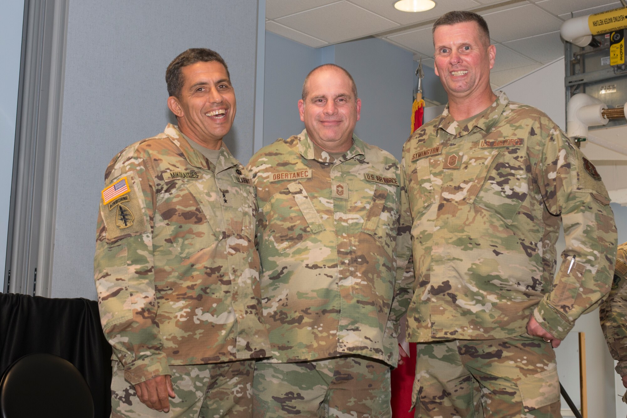 Maj. Gen. David Mikolaities, adjutant general, New Hampshire National Guard, Chief Master Sgt. David Obertanec, former state command chief, and Chief Master Sgt. John Symington, state command chief pose for picture before the change of command ceremony at Pease Air National Guard Base, Sept. 15, 2019. Symington assumed the state command chief position during the ceremony. (U.S. Air National Guard photo by Senior Airman Victoria Nelson)