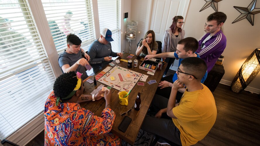 Airmen from the 2nd Operational Support Squadron air traffic control tower get together for their monthly first Friday team dinner in Bossier City, Louisiana, Sept. 20, 2019.