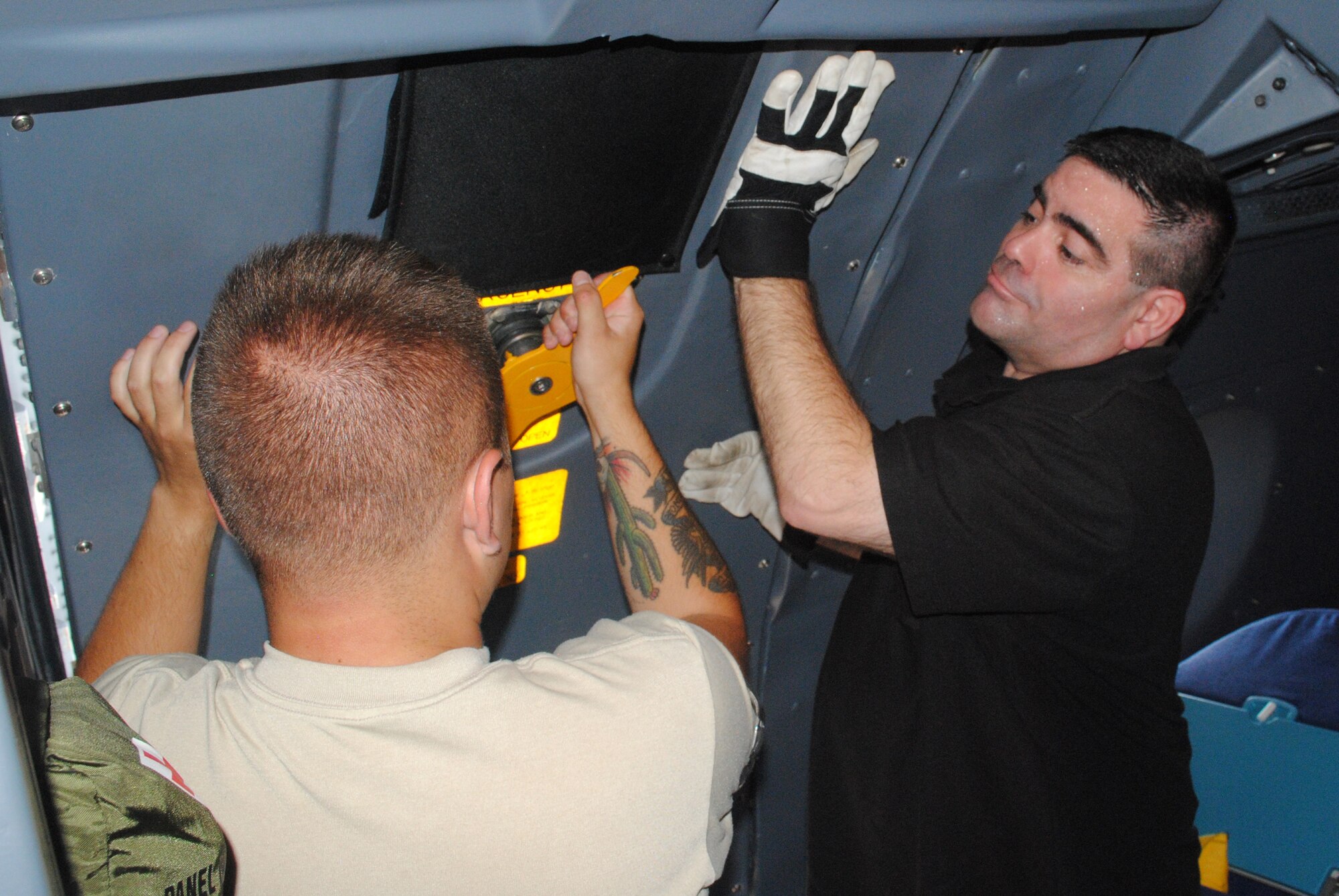 A maintenance Airman talks about a C-5M Super Galaxy to civilians and veterans inside the C-5M.