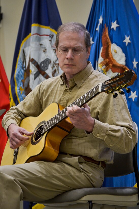 Raymond Smith, DLA Troop Support Clothing and Textile contract specialist, performs two short guitar selections written by Fernando Sor, a Spanish classical guitarist and composer, during the annual Hispanic Heritage Month celebration Sept. 25, 2019 in Philadelphia.  Troop Support and Naval Supply Systems Command Weapon Systems Support employees celebrated the culture and traditions of Hispanic Americans during a National Hispanic Heritage Month program.
