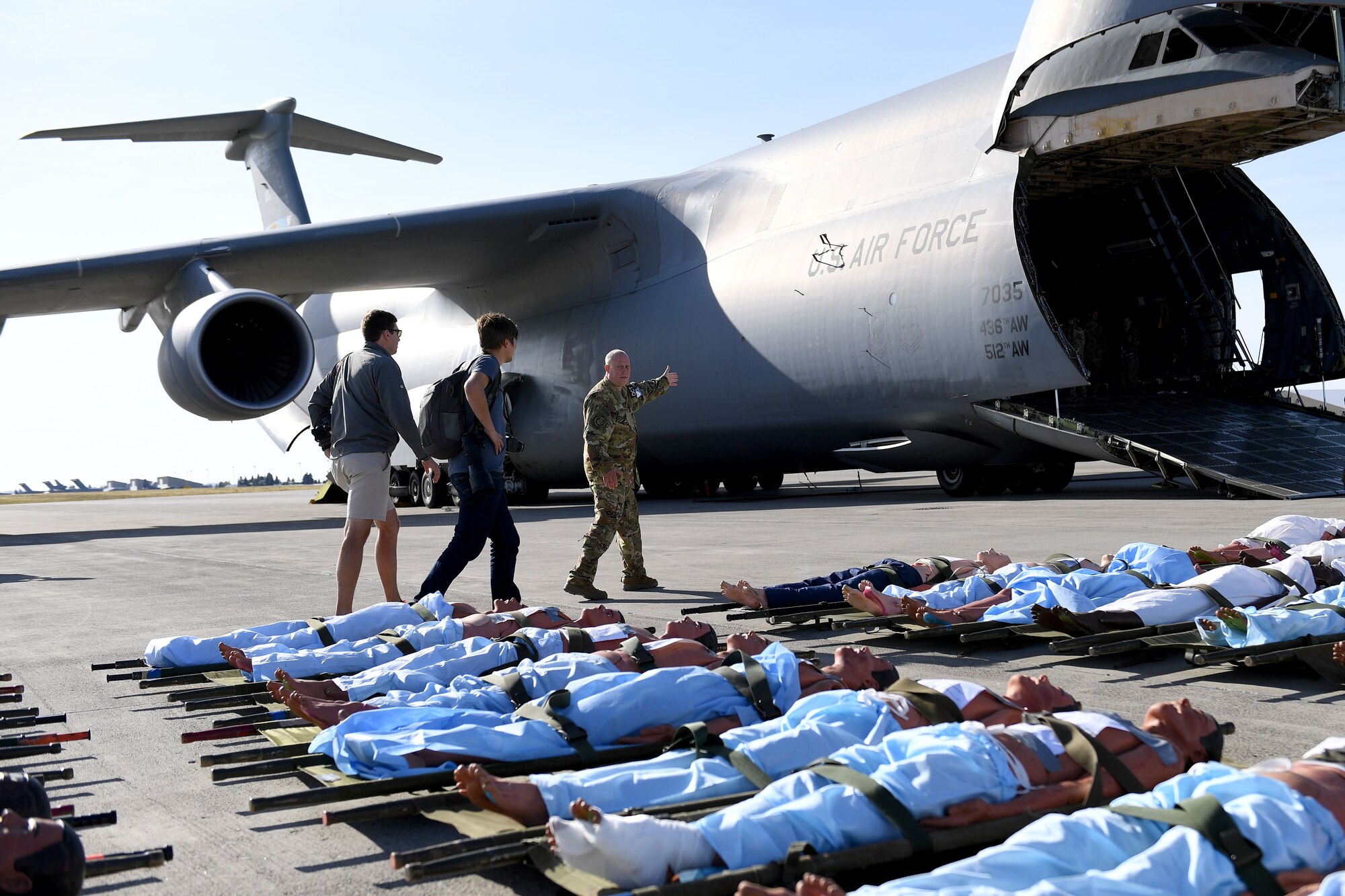 People sit outside a plane.