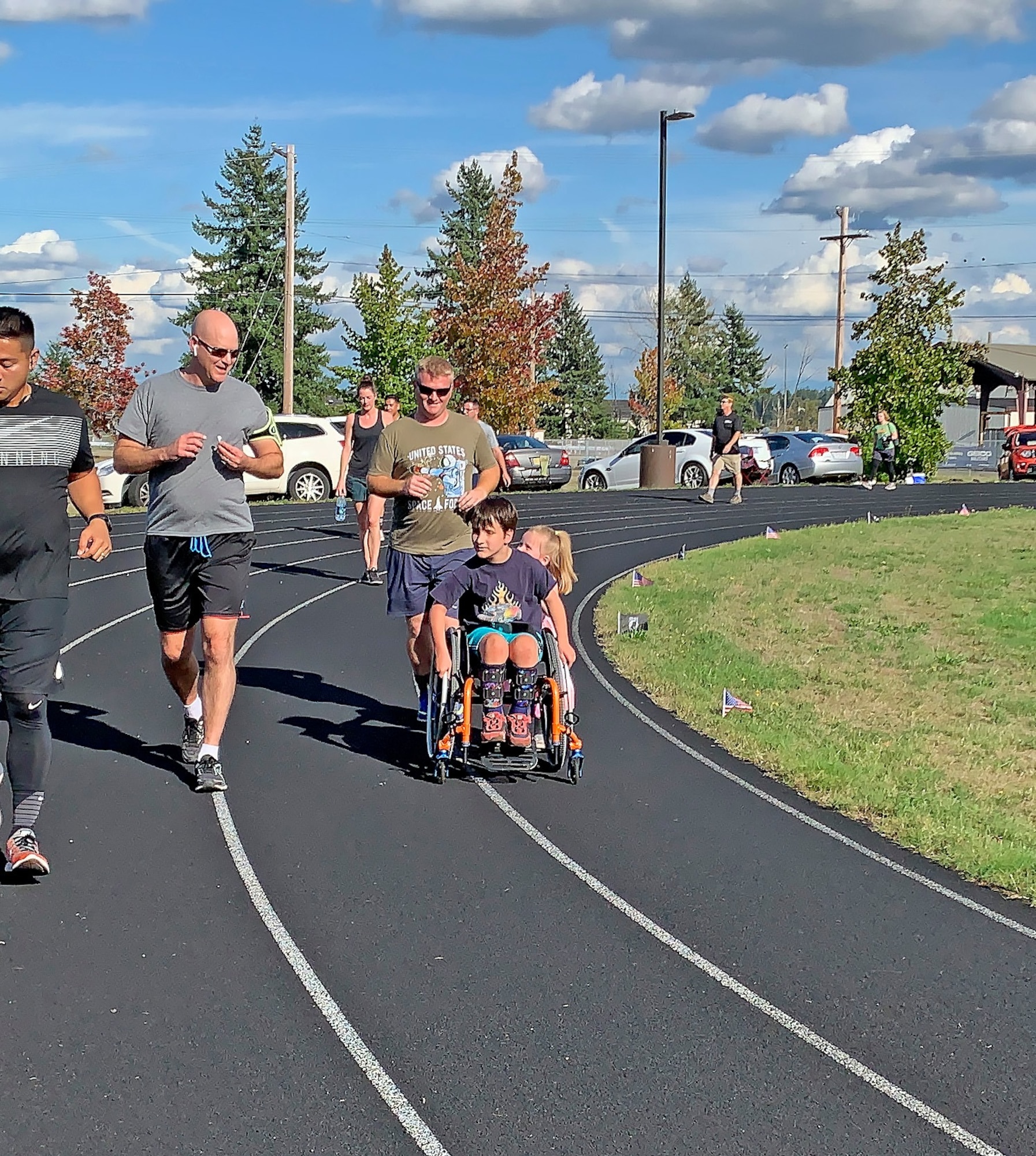 Col. Brett Bosselmann (left), 225th Support Squadron commander, runs with Master Sgt. Eric Poe and his children during the POW/MIA Remembrance Run Sept. 18, 2019 at Joint Base Lewis-McChord. (Courtesy photo).