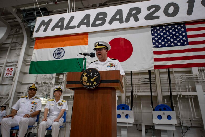 SASEBO, Japan (Sept. 26, 2019) Rear Adm. Jimmy Pitts, Commander Submarine Group 7, gives opening remarks at the Malabar 2019 opening ceremony aboard the Japanese helicopter destroyer JS Kaga (DDH-184). Malabar is an annual multinational maritime exercise started in 1992 with the Indian Navy and most recently, the Japan Maritime Self-Defense Force to increase cooperation among allied and partner nations in the Indo Pacific.