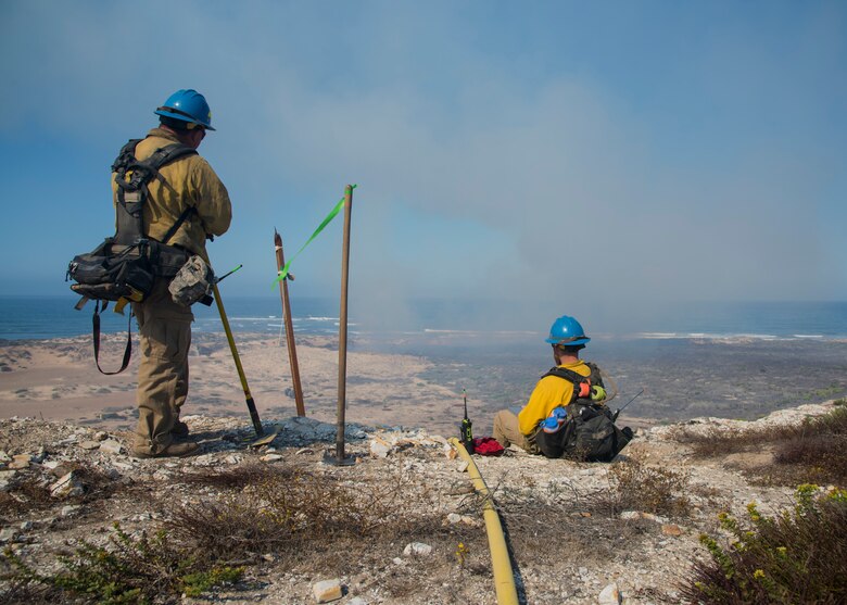 Fire operation technicians observe a controlled fire