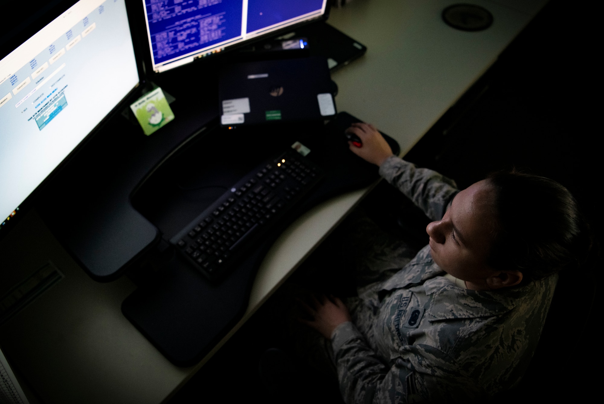 woman sits in front of computer