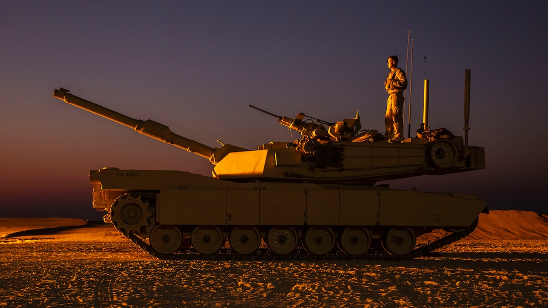 A U.S. Marine stands atop an M1A1 Abrams tank, Aug. 20.