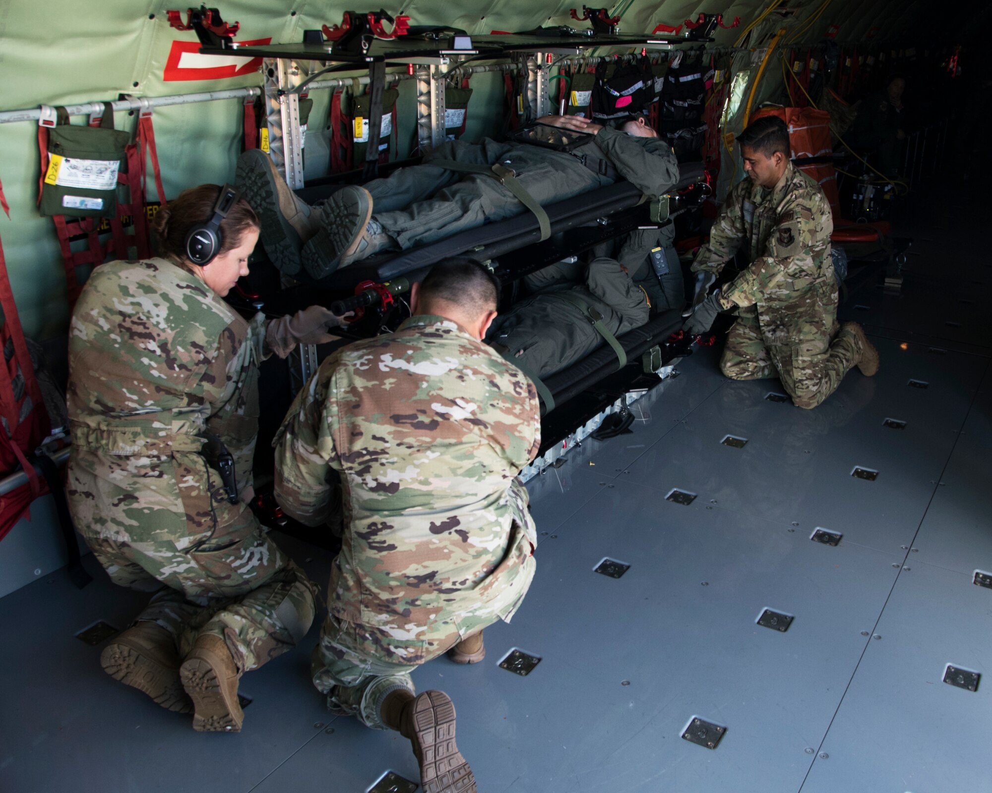 Members of the 459th Aeromedical Evacuation Squadron place a patient onto a Stanchion Litter System in preparation for an off station trainer Sept. 20, 2019, at Joint Base Andrews, Md. The team conducted the training on the way to Wright Patterson Air Force Base, Ohio, where they also ran in the Air Force Marathon. (U.S. Air Force photo by Staff Sgt. Cierra Presentado/Released)