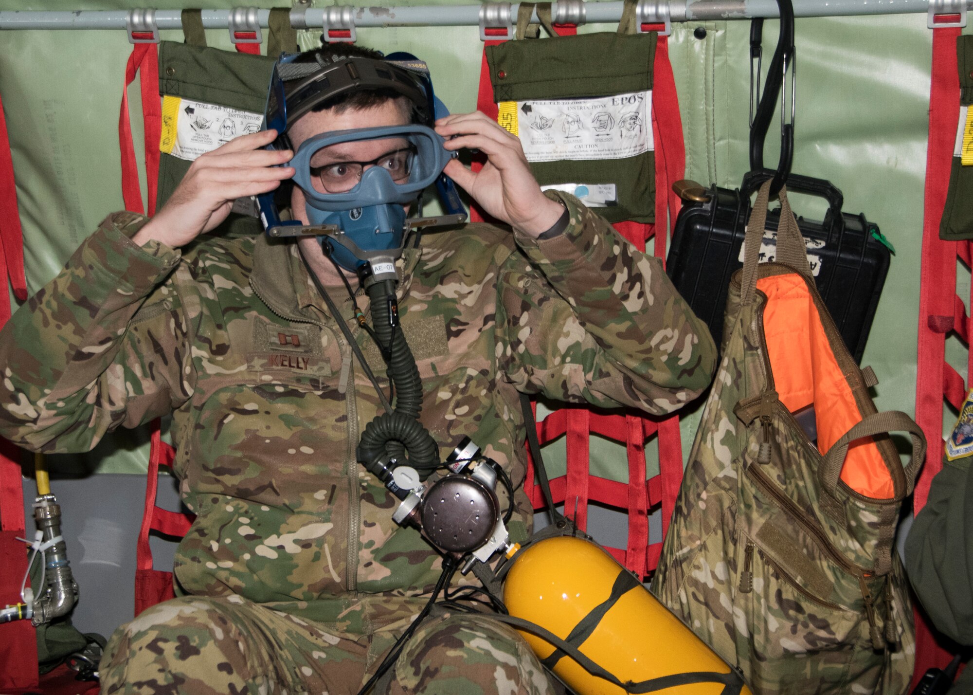 Capt. Ryan Kelly, 459 Aeromedical Evacuation Squadron flight nurse, puts on his oxygen mask during an in-flight aircraft emergency, as part of the teams off station trainer Sept. 20, 2019. The AES team conducted training on a KC-135 Stratotanker during a flight to Wright Patterson, Ohio, where they later participated in the Air Force Marathon. (U.S. Air Force photo by Staff Sgt. Cierra Presentado/Released)