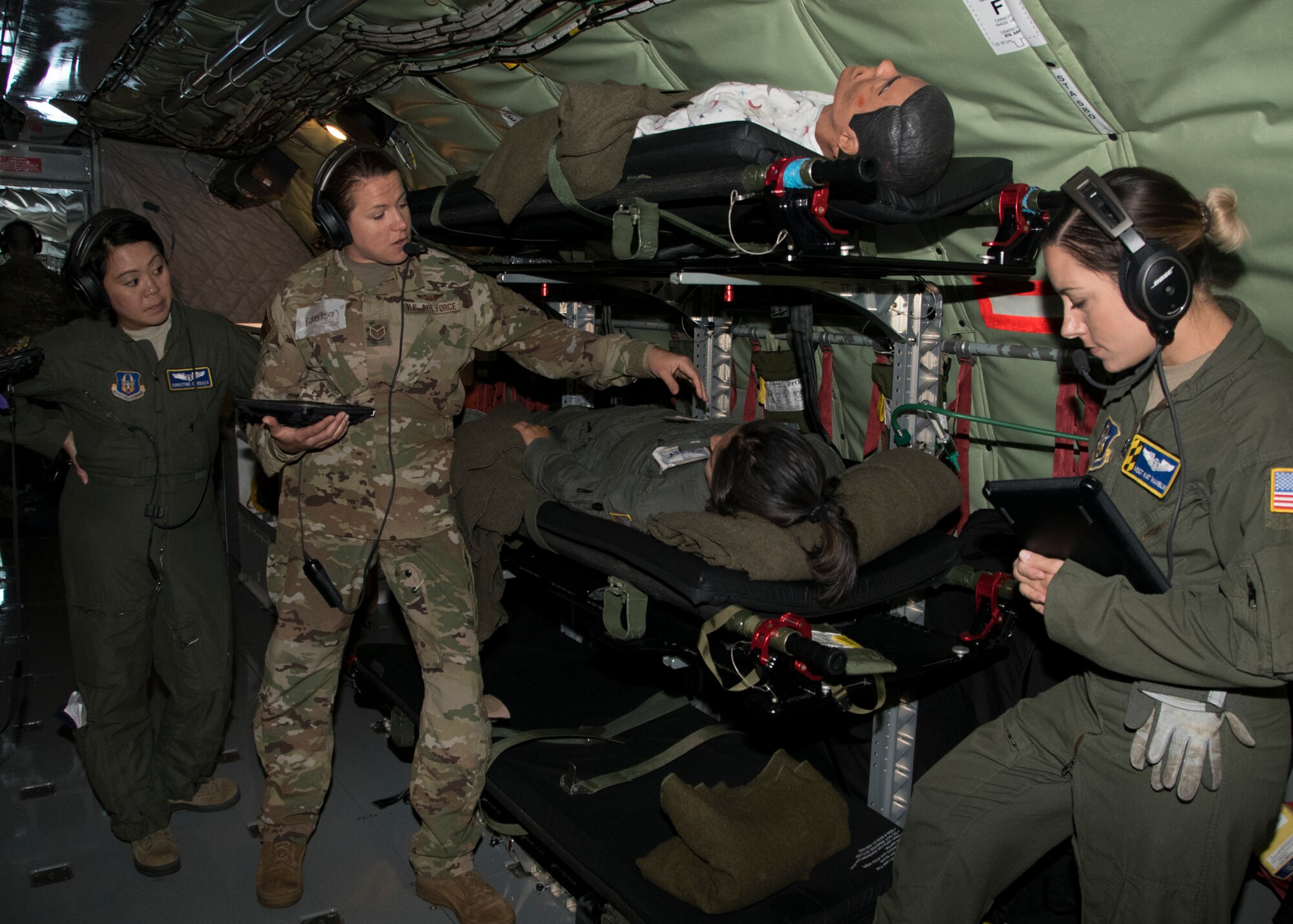 Staff Sgt. Sarah Loudon, 459th Aeromedical Evacuation Squadron flight medic, explains an abdominal medical issue that can occur in-flight to her team during an off station trainer on a KC-135 Stratotanker, Sept. 20, 2019. The team participates in local and off station training missions about twice a month to ensure humanitarian and deployment mission readiness. (U.S. Air Force photo by Staff Sgt. Cierra Presentado/Released)