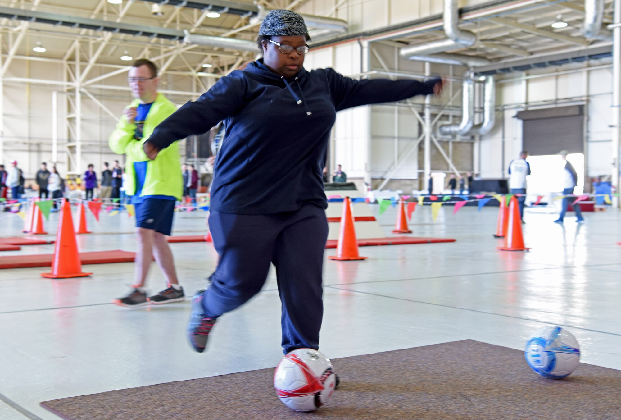 An athlete kicks a soccer ball during the 38th Annual Joan Mann Special Sports Day at RAF Mildenhall, England, Sept. 27, 2019. Joan Mann was a Ministry of Defence employee who worked in the RAF Mildenhall Public Affairs office many years ago. She organized the special sports day as a way to offer community members with special-needs a day of fun, and to bring the military and local community closer together. (U.S. Air Force photo by Staff Sgt. Matthew J. Wisher)