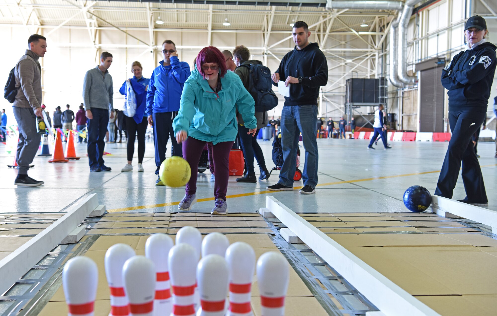 An athlete rolls a bowling ball during the 38th Annual Joan Mann Special Sports Day at RAF Mildenhall, England, Sept. 27, 2019. Approximately 600 volunteers from RAF Mildenhall, RAF Lakenheath, Airman Leadership School at RAF Feltwell, and RAF Honington assisted the special athletes. (U.S. Air Force photo by Staff Sgt. Matthew J. Wisher)
