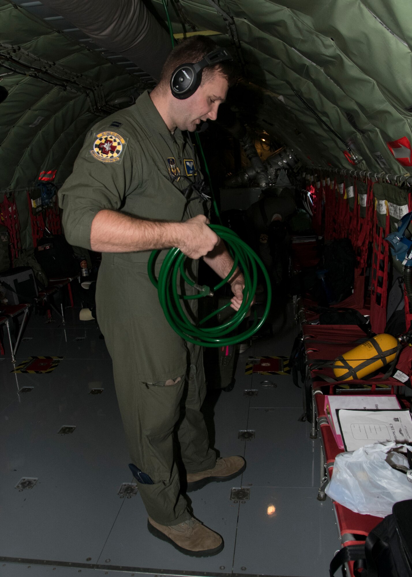 Capt. Joseph Dabbs, 459th Aeromedical Evacuation Squadron flight nurse, unravels an oxygen hose, as part of an off station trainer on a KC-135 Stratotanker Sept. 20, 2019, at Joint Base Andrews, Md. Members from the AES team conducted training on the way to Wright Patterson Air Force Base, Ohio, where they also ran in the Air Force Marathon. (U.S. Air Force photo by Staff Sgt. Cierra Presentado/Released)