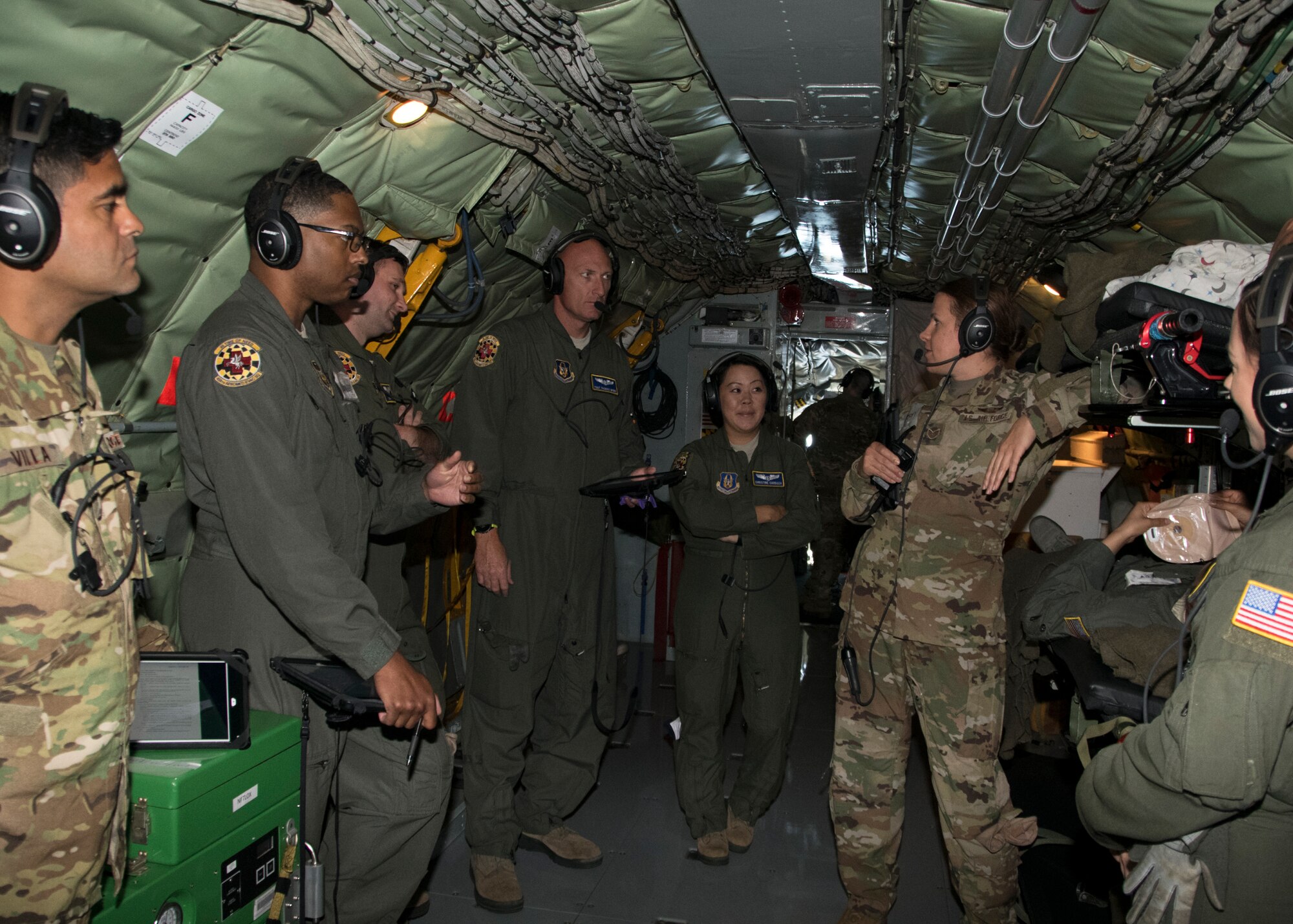 Members of the 459th Aeromedical Evacuation Squadron, have a group discussion while on board a KC-135 Stratotanker as part of an off station trainer, Sept. 20, 2019. The AES team conducted training during a flight to Wright Patterson, Ohio, where they later participated in the Air Force Marathon. (U.S. Air Force photo by Staff Sgt. Cierra Presentado/Released)