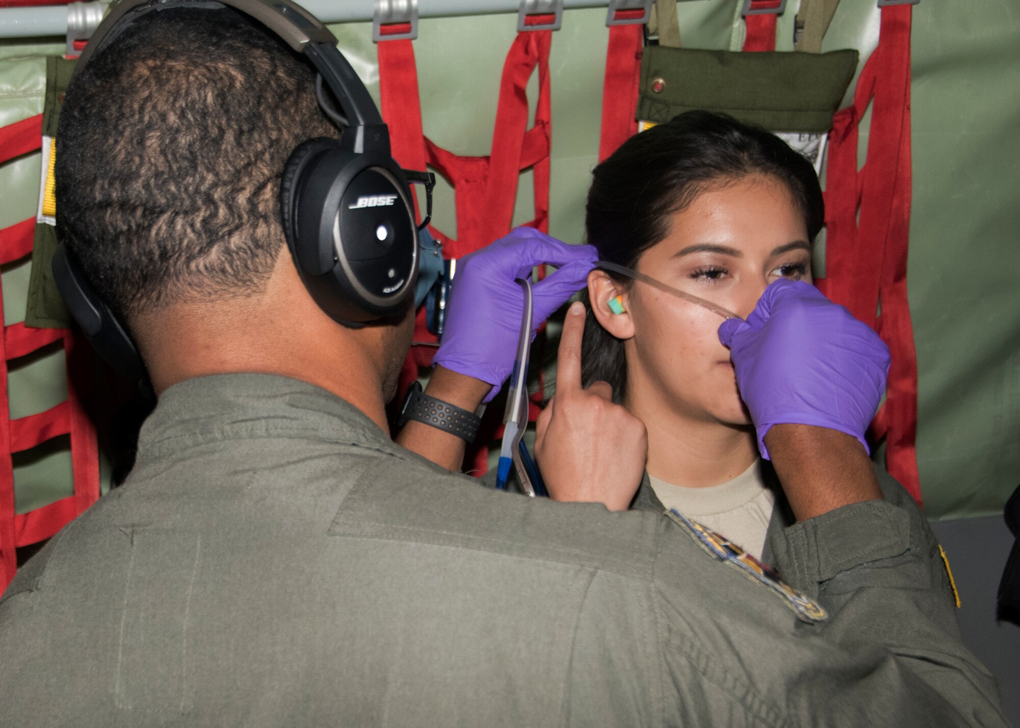 Senior Airman Jesse McNeal, 459th Aeromedical Evacuation Squadron, flight medic, simulates inserting a nasal gastric tube onto Senior Airman Maria Moposita during an off station trainer on a KC-135 Stratotanker Sept. 20, 2019. The AES team conducted training during a flight to Wright Patterson, Ohio, where they later participated in the Air Force Marathon. (U.S. Air Force photo by Staff Sgt. Cierra Presentado/Released)