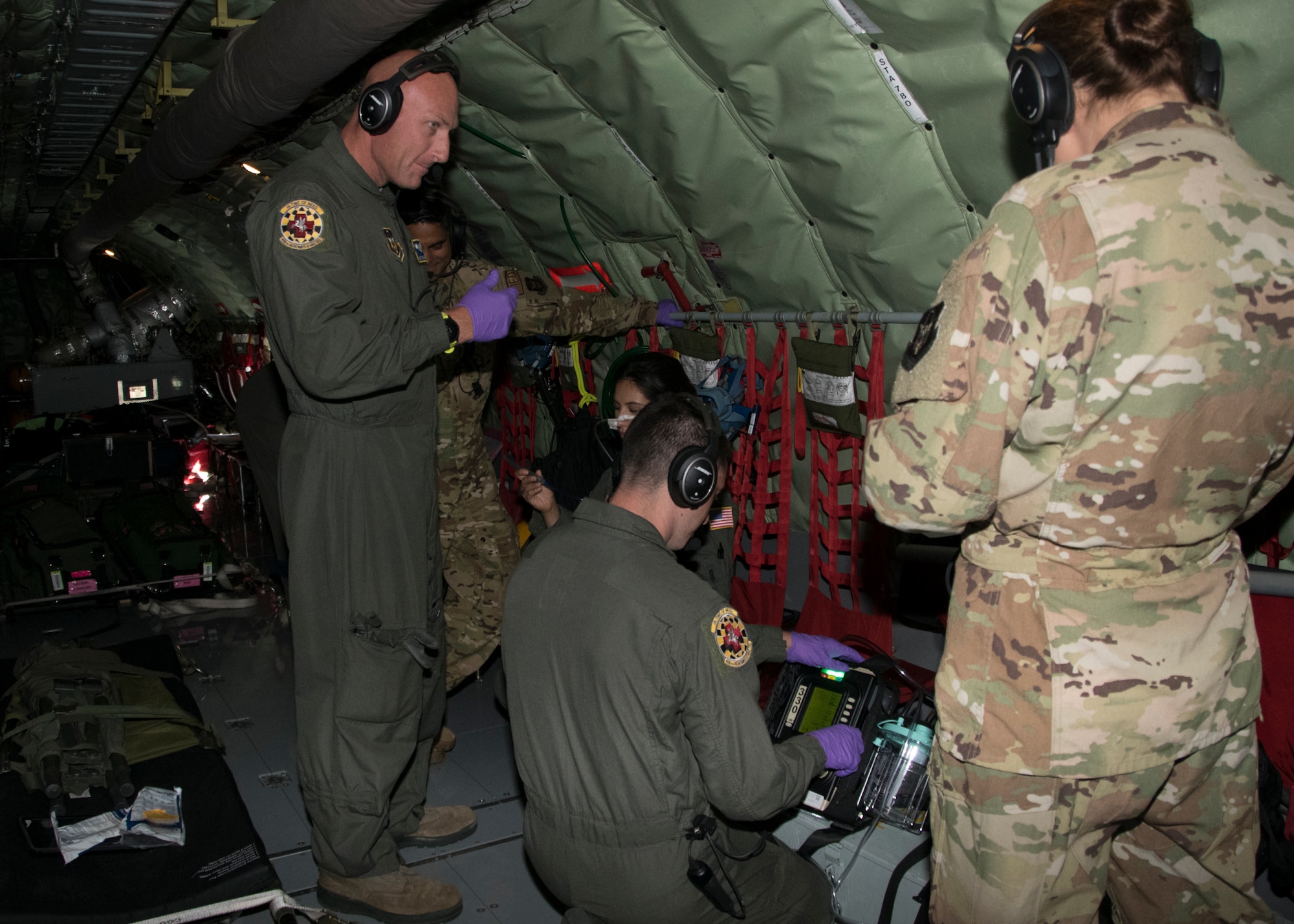 Tech Sgt. Thomas Green, 459th Aeromedical Evacuation Squadron flight medic, helps his crew set up a nasal gastric tube suction as part of an off station trainer on a KC-135 Stratotanker, Sept. 20, 2019. The AES team conducted training during a flight to Wright Patterson, Ohio, where they later participated in the Air Force Marathon. (U.S. Air Force photo by Staff Sgt. Cierra Presentado/Released)