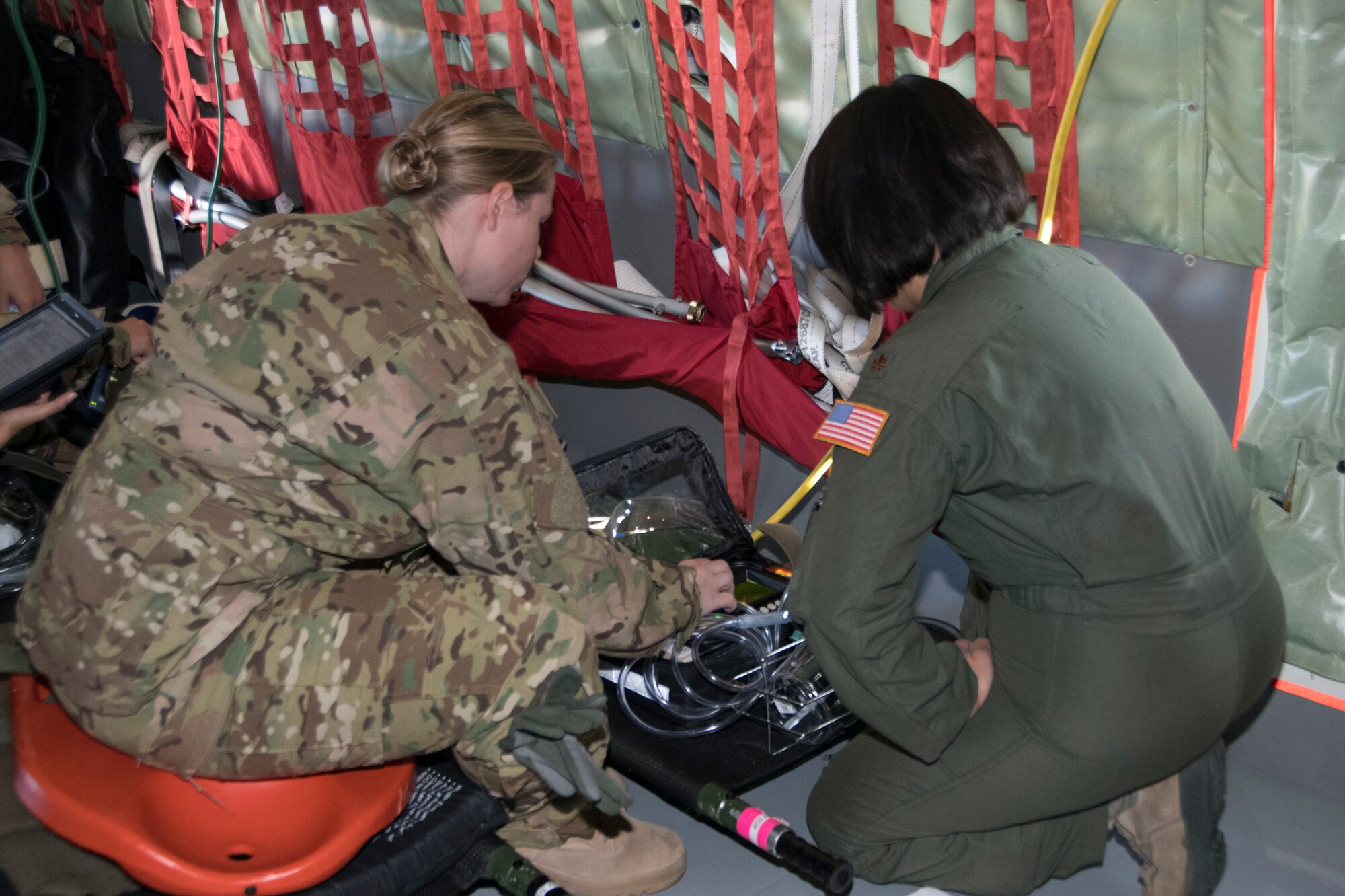 Capt. Lindsey Hammer, 459th Aeromedical Evacuation Squadron flight nurse (left) assists Maj. Christine Cardoza, flight nurse, in a function check of medical equipment prior to taking off for an off station trainer Sept. 20, 2019 at Joint Base Andrews, Md. The team participates in local and off station training missions about twice a month to ensure humanitarian and deployment mission readiness. (U.S. Air Force photo by Staff Sgt. Cierra Presentado/Released)