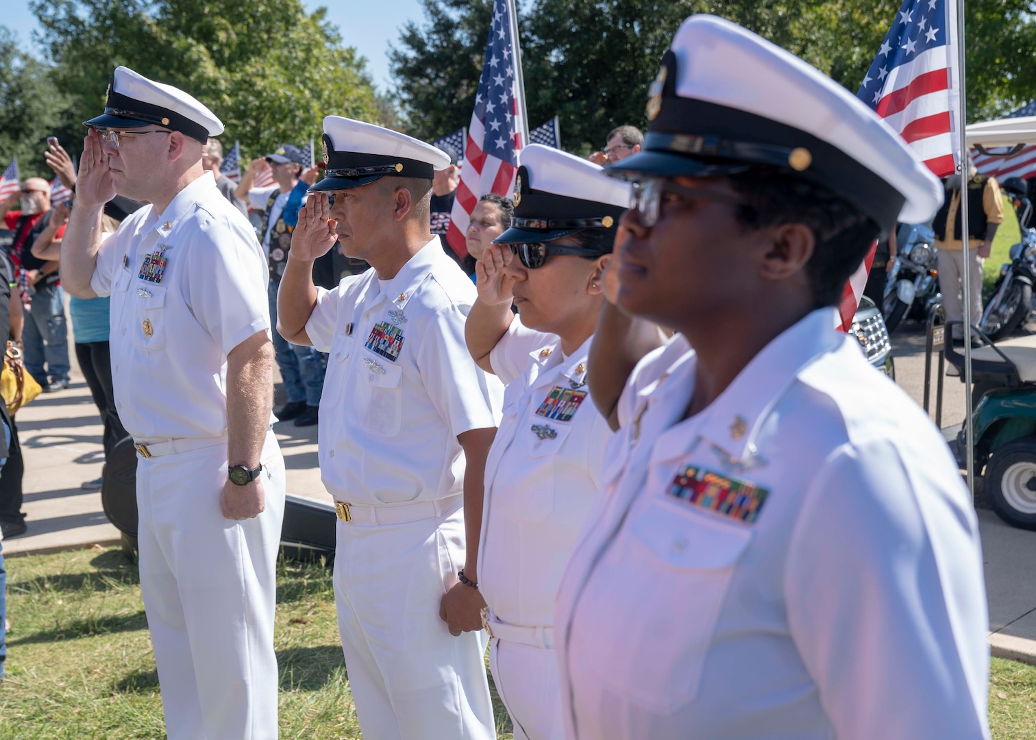 Navy Medicine Education, Training and Logistics Command Sailors salute during the playing of taps during a graveside funeral service Petty Officer 3rd Class Mark Lyle Walker, a sonar technician (submarine), in Killeen, Texas, Sept. 26. Walker, a submarine veteran, had no family or next of kin, prompting the NMETLC, Navy Medicine Training Support Center and Navy Recruiting District San Antonio Sailors to make the two-hour drive from Joint Base San Antonio to honor Walker's Navy service.