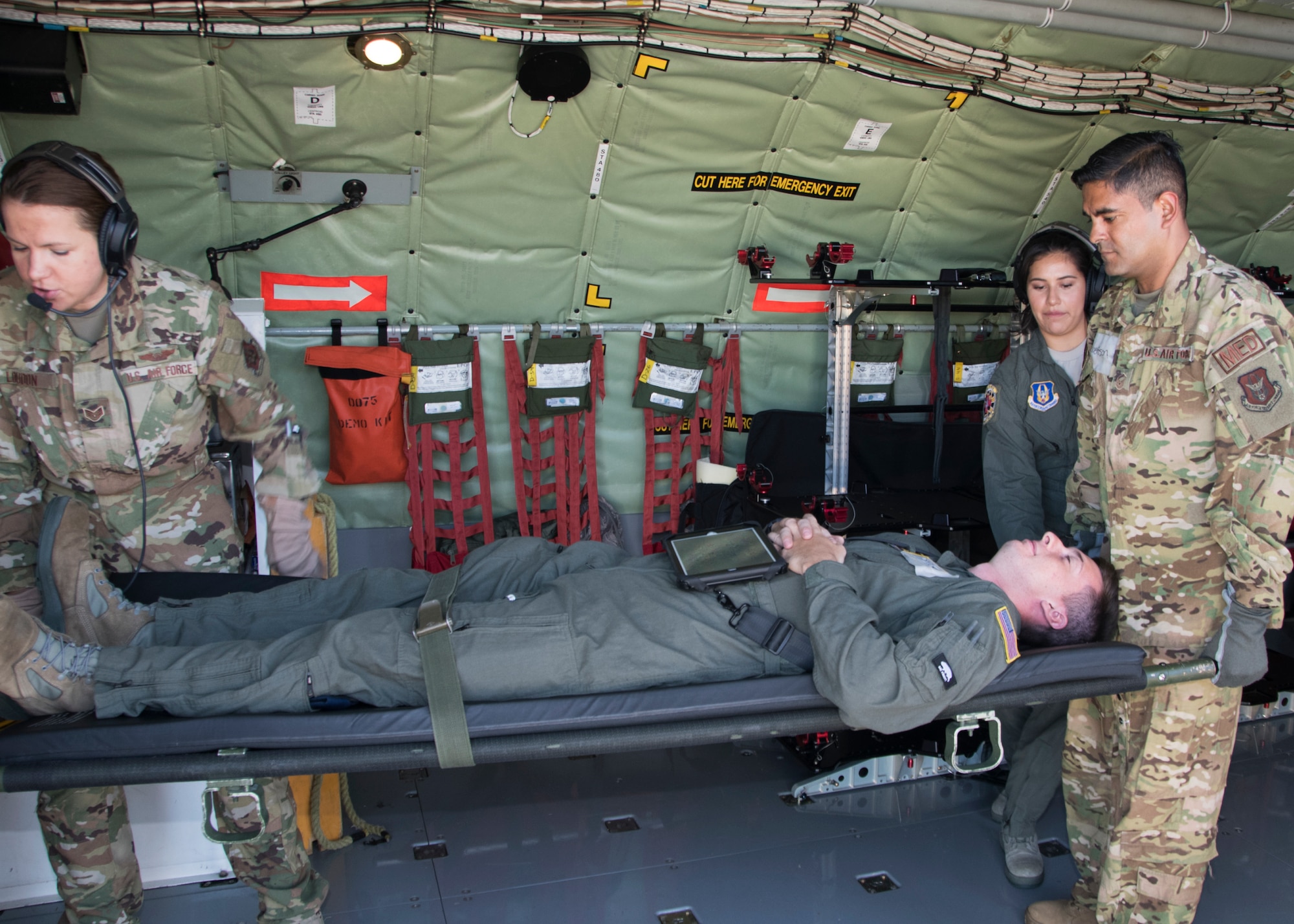 Members of the 459th Aeromedical Evacuation Squadron, lift a patient onto a Stanchion Litter System in preparation for an off station trainer on a KC-135 Stratotanker Sept. 20, 2019. The AES team conducted training during a flight to Wright Patterson, Ohio, where they later participated in the Air Force Marathon. (U.S. Air Force photo by Staff Sgt. Cierra Presentado/Released)
