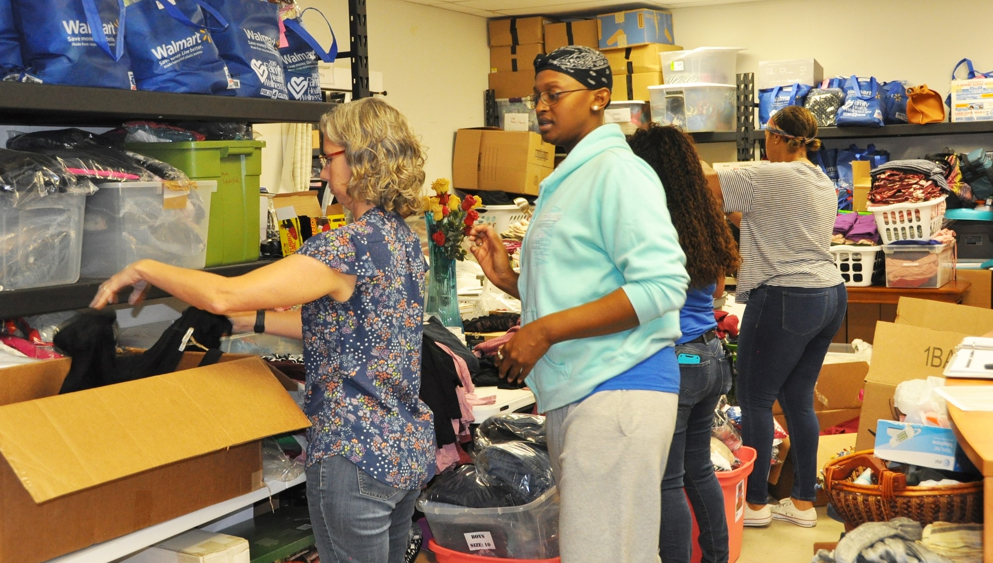 Volunteers (left to right) Lt. Col. Teresa Davies, Master Sgt. Faith Wells, Master Sgt. Julia Tovar  and Capt. Yolanda Seals sort clothing during a 340th Flying Training Group Sept. 11 community outreach event at the San Antonio, Texas Family Violence Prevention Services/Battered Women and Children’s Shelter’s Donation Center. (U.S. Air Force photo by Janis El Shabazz)