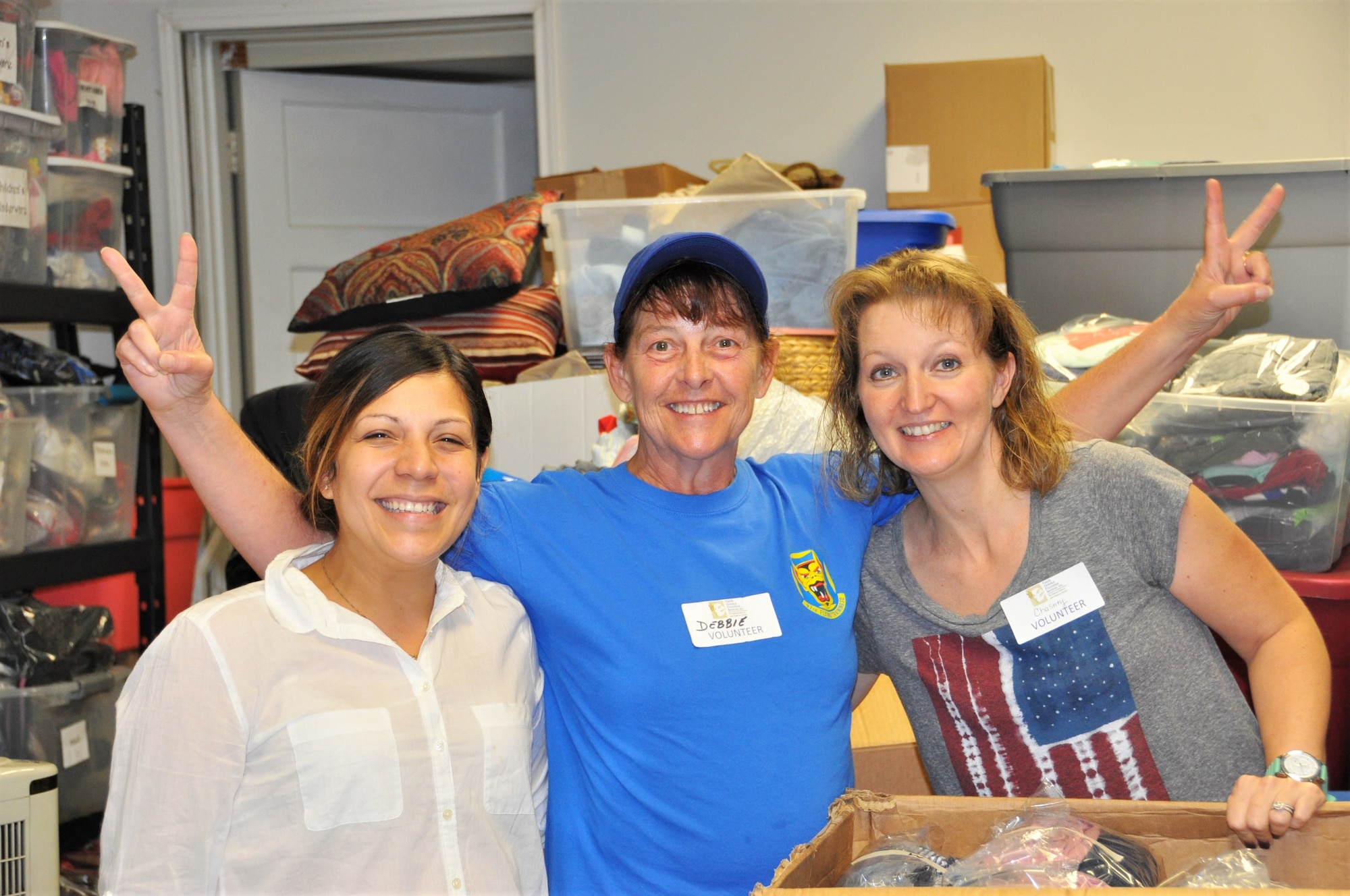 Priscilla Mendoza, San Antonio, Texas Family Violence Prevention Services/Battered Women and Children’s Shelter’s Donation Center assistant (left), and 340th Flying Training Group volunteers Debbie Gildea and Chastity Ramirez pose for a photo during the group's Sept. 11 community outreach event. Mendoza said the 16 boxes sorted and packed by 340th FTG members saved the center a week of work. (U.S. Air Force photo by Janis El Shabazz)