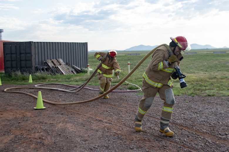 The team for the 97th Communications Squadron drag a hose, Sept. 26, 2019, at Altus Air Force Base, Okla.