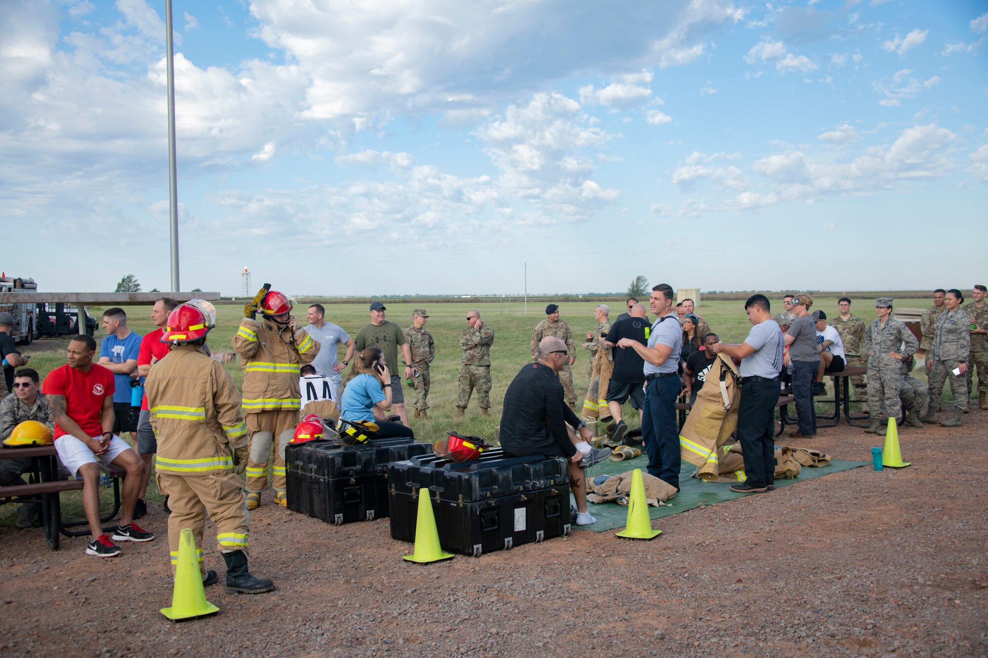 Members of the 97th Air Mobility Wing change in and out of firefighting gear