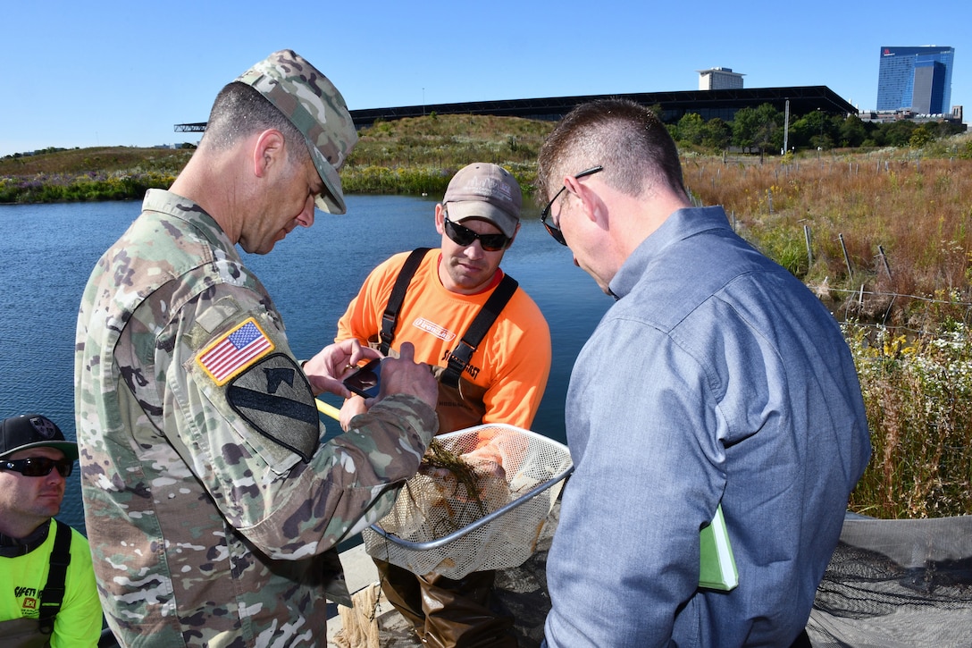 Matt Shanks (center), fish biologist for the U.S. Army Corps of Engineers Chicago District, shows Maj. Gen. Robert F. Whittle, Jr., commanding general of the USACE Great Lakes and Ohio River Division, and Joseph Savage (right), the division’s regional business director, fish caught during an electrofishing demonstration at Northerly Island in Chicago Sept. 26. The general took time to visit the districts within the division and meet USACE employees since taking command in July. The general’s tour of Chicago District projects, potential projects and sites included Indiana Harbor and Canal confined disposal facility, Bubbly Creek in Chicago, the Asian-Carp electric dispersal barrier, the Metropolitan Water Reclamation District of Greater Chicago’s mainstream pumping station, the McCook Reservoir phase one and two, Northerly Island in Chicago, the Chicago Harbor and Lock, and the Department of Veterans Affairs Hospital in Hines, Illinois. (U.S. Army photo by Patrick Bray/Released)