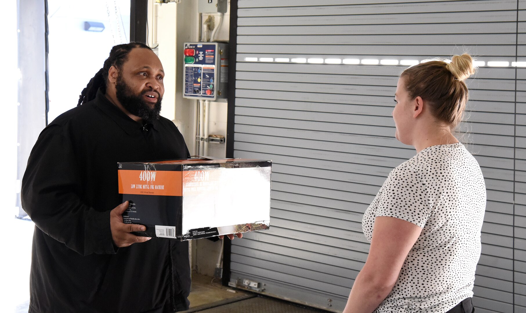 Male presents box to female during active shooter exercise.