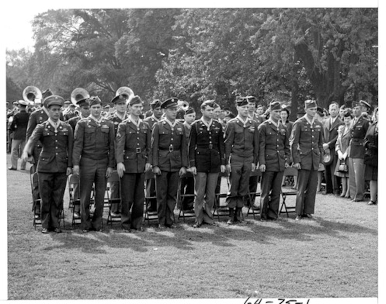 Two rows of eight soldiers stand at attention on the White House lawn wearing Medals of Honor.