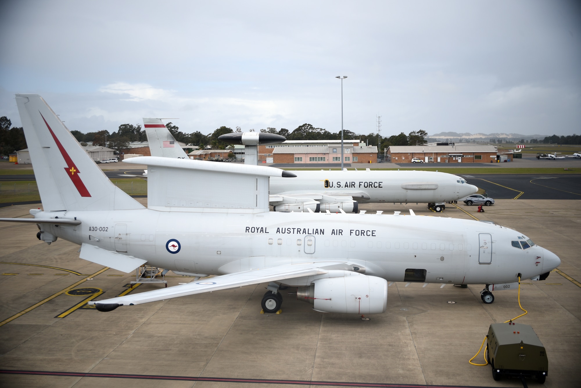 Despite similar missions, the radar differences become more obvious as the E-3 Sentry Airborne Warning and Control System joins the E-7 Wedgetail Airborne Warning Early Control aircraft at Royal Australian Air Force Base Williamtown in September 2019. This visit allowed for joint-mission flying sorties and integration among allies and similar platforms. (U.S. Air Force photo /2nd Lt. Ashlyn K. Paulson)