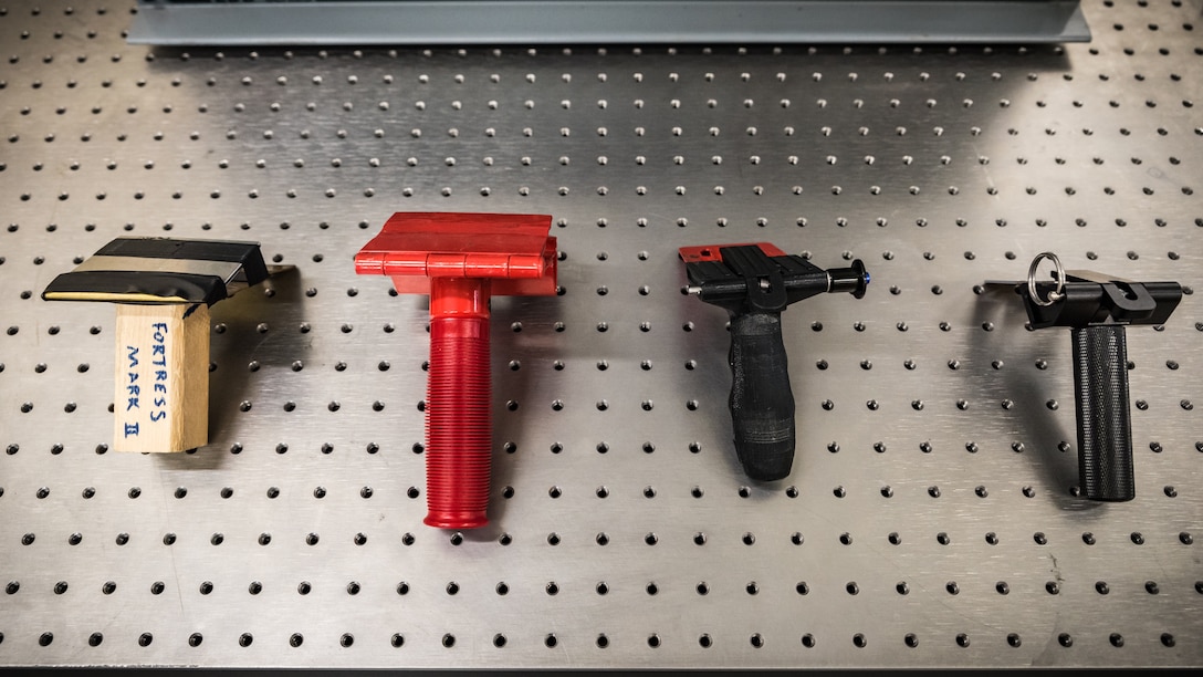 Shown here are four different prototypes of portable door locks at various stages in development. The Air Force Research Laboratory team that developed these has been selected for a 2019 Defense Innovation Award. (U.S. Air Force photo/Richard Eldridge)