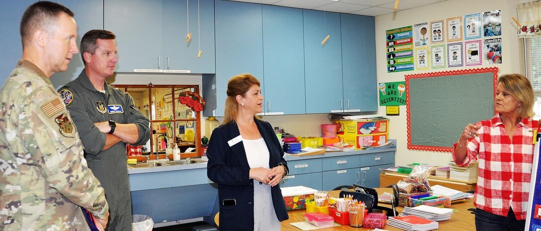 Blanca Uribe, Family Violence Prevention Services/Battered Women and Children’s Shelter external affairs and volunteer relations director (center) introduces Chief Master Sgt. Scott Goetze, 340th Flying Training Group superintendent (left) and Col. Brent Drown, deputy commander, to Kathy Smith, BWCS instructional assistant, during an Aug. 27 tour of the facility prior to the group's Sept. 11 community outreach event at the shelter's donation center. (U.S. Air Force photo by Janis El Shabazz)