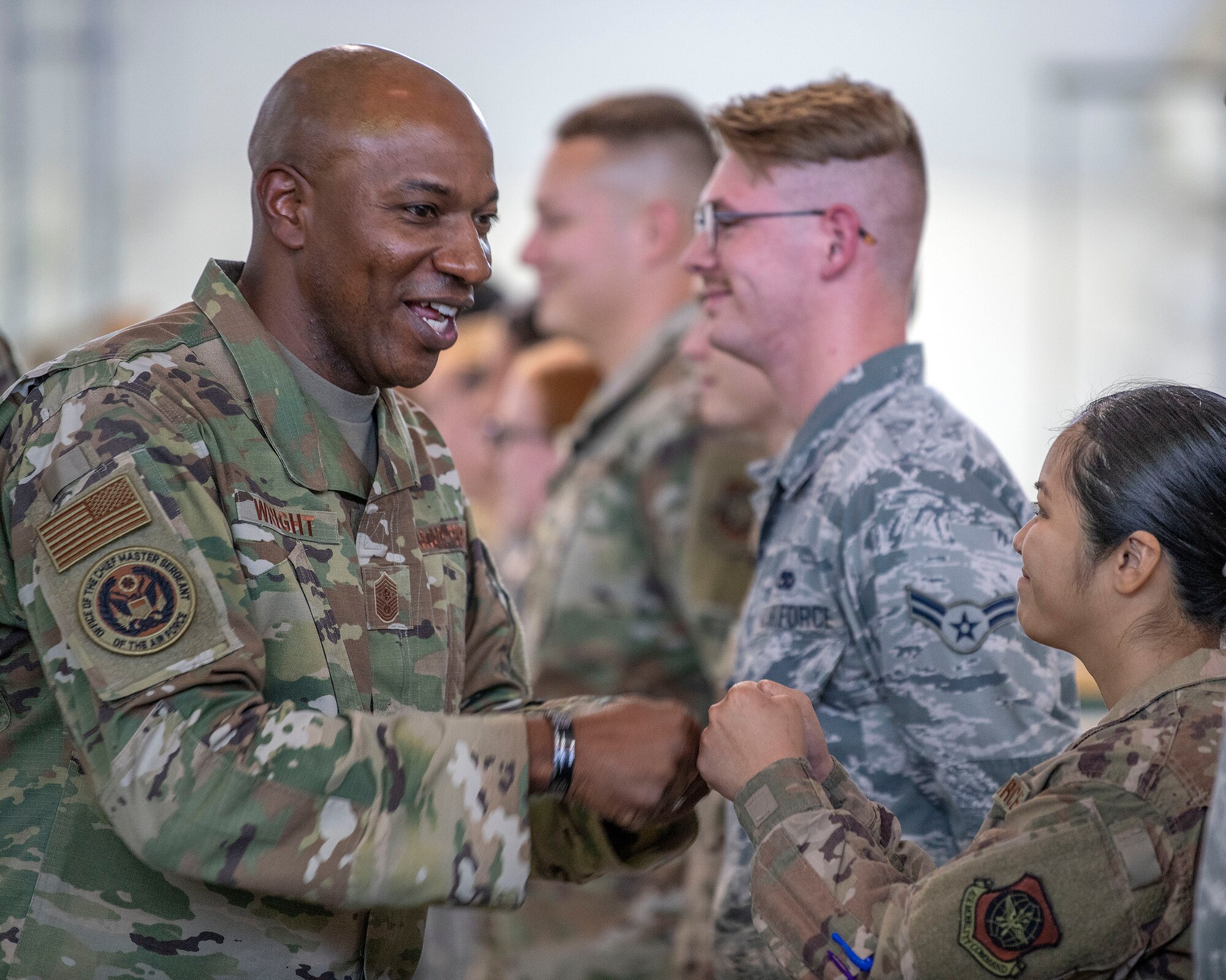 Chief Master Sgt. of the Air Force Kaleth O. Wright fist bumps Airmen