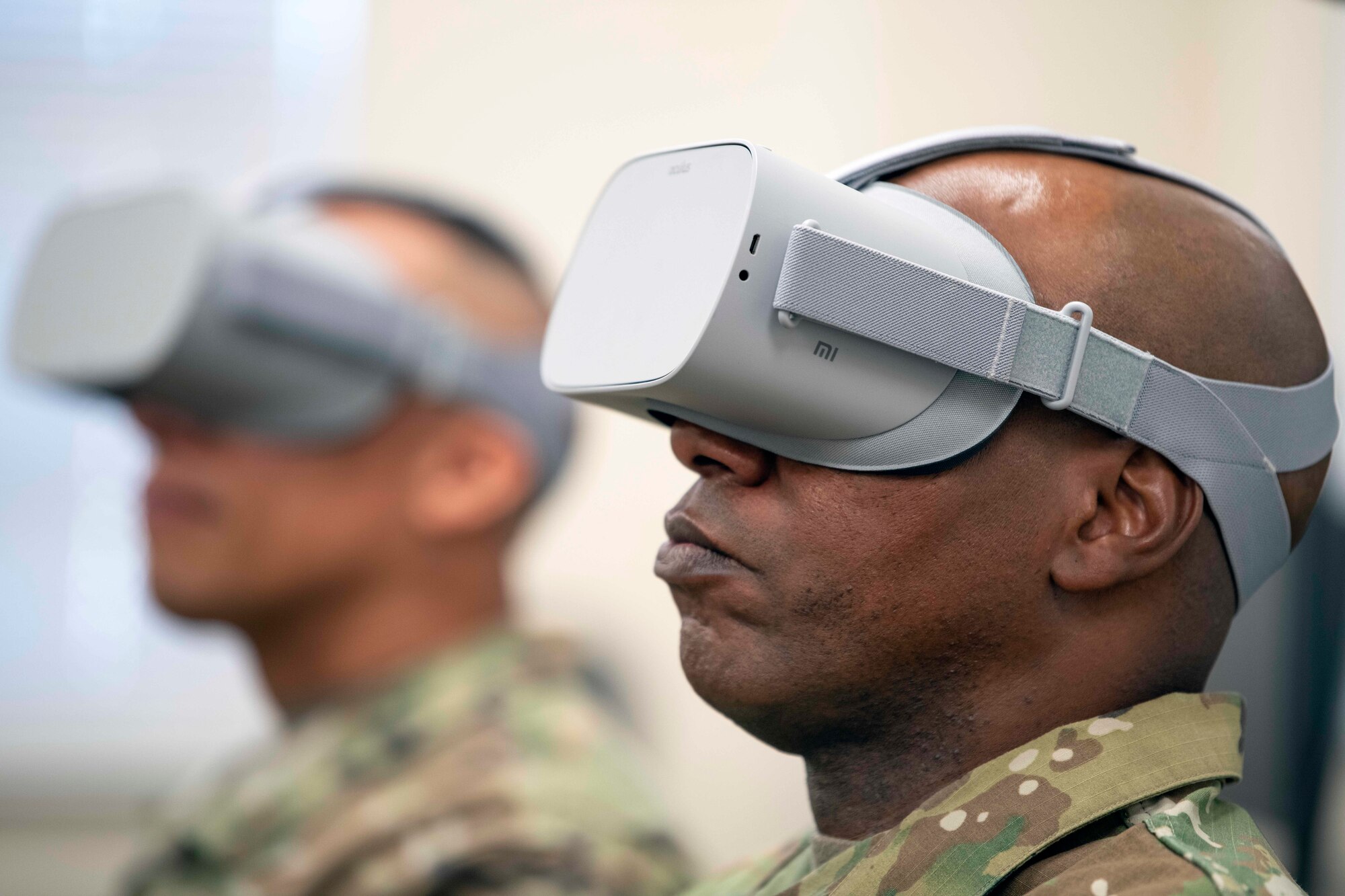 Chief Master Sgt. of the Air Force Kaleth O. Wright, right, and Chief Master Sgt. Manny Piñeiro, left, Air Force First Sergeant Manager, watch KC-10 Extender air refueling with virtual reality goggles