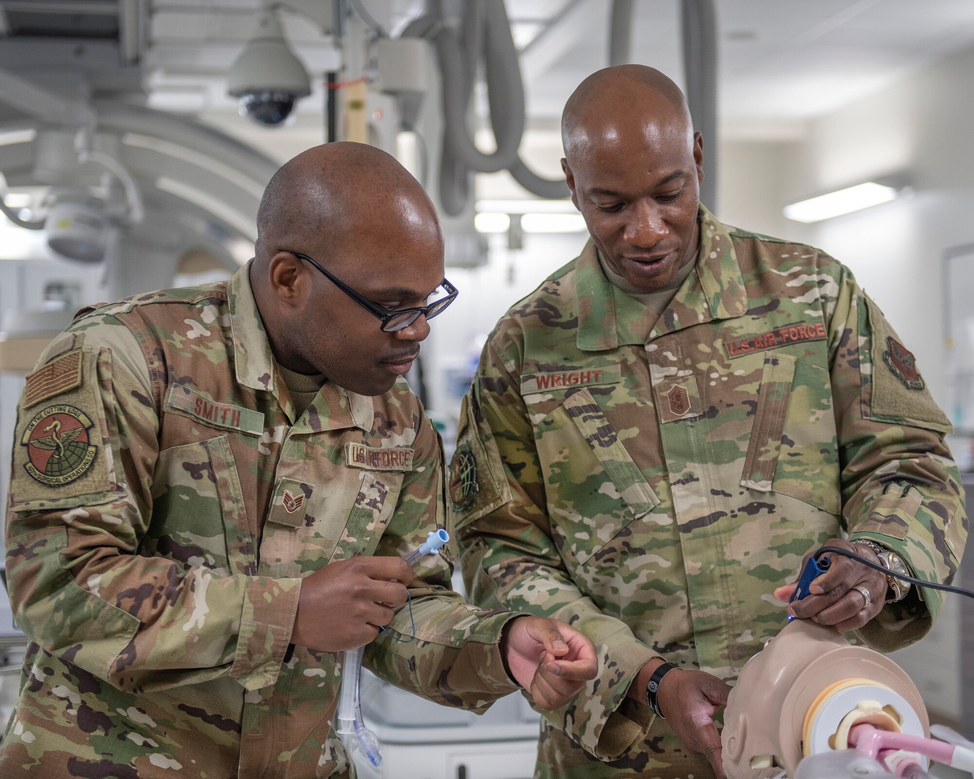 Chief Master Sgt. of the Air Force Kaleth O. Wright, uses an endotracheal intubation simulator with the assistance of Staff Sgt. Romarus Smith