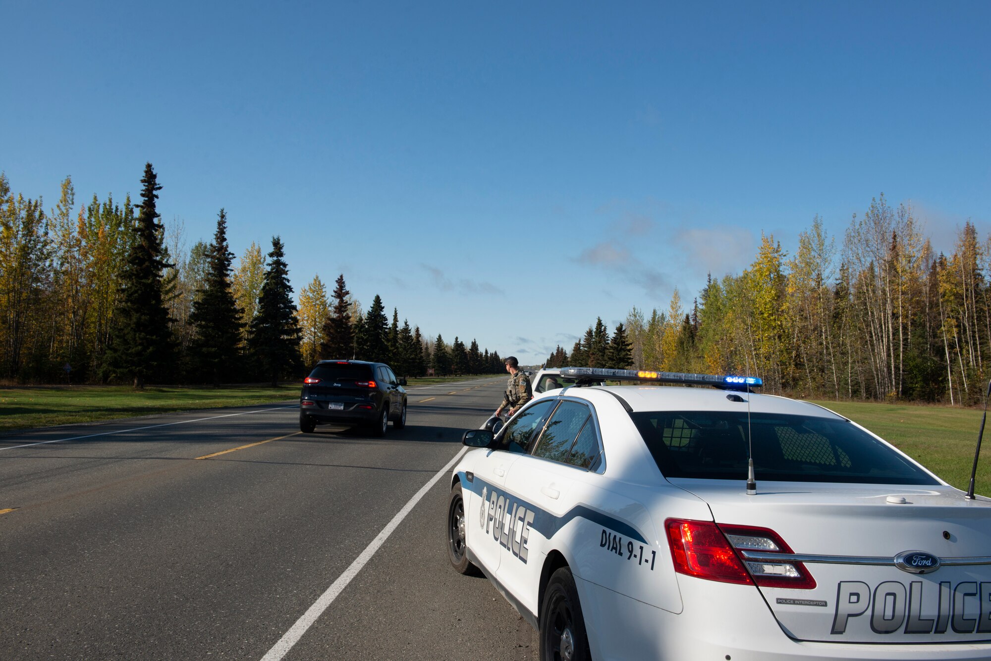 U.S. Air Force Staff Sgt. Steven Garwood, 673d Security Forces noncommissioned officer in charge of confinement, slows down a driver who failed to yield at Joint Base Elmendorf-Richardson, Alaska, Sept. 26, 2019. Garwood demonstrated the importance of yielding to emergency vehicles during a simulated traffic stop.