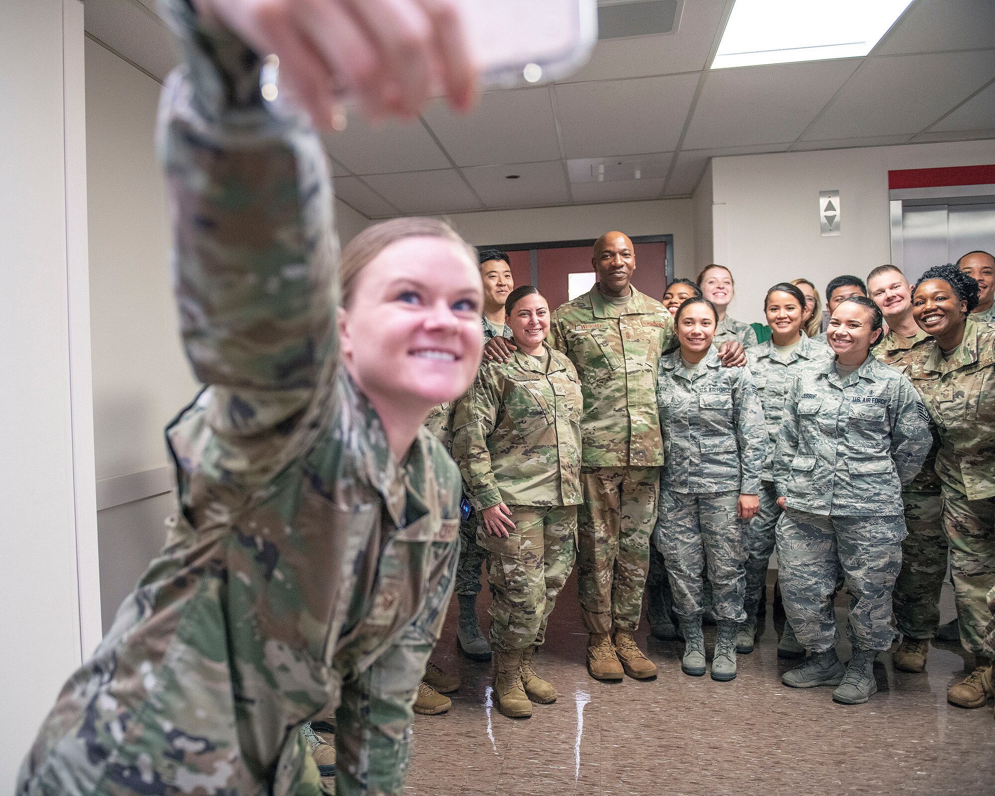 A group of U.S. Airmen take a selfie with Chief Master Sgt. of the Air Force Kaleth O. Wright